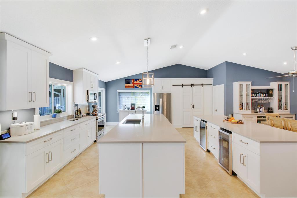 STUNNING & not a thing to do but enjoy! Everything has been done to the greatest of detail in this perfect 4BR/2BA/2CG home w/ 2185 Liv SF & 2978 Total SF. HUGE, open kitchen w/ TWO islands, quartz counters, TONS of storage, new appliances, 2 wine fridges, large pantry w/ butcher block. New roof (2022). Impact windows/sliders (2019). New AC/ducts/returns (2020). New interior doors/baseboards/moldings. New modern Baths. No popcorn. GORGEOUS, private yard w/ no rear neighbors (backs to golf course), travertine pavers & resurfaced pool. Spacious .24 acre lot. Travertine circular drive & front porch. Quiet & desirable area w/in Pheasant Walk! Great community - private park, sidewalks, dedicated police officer, buried utilities,HS Fiber, low HOA & pet friendly! Excellent A-rated public schools!