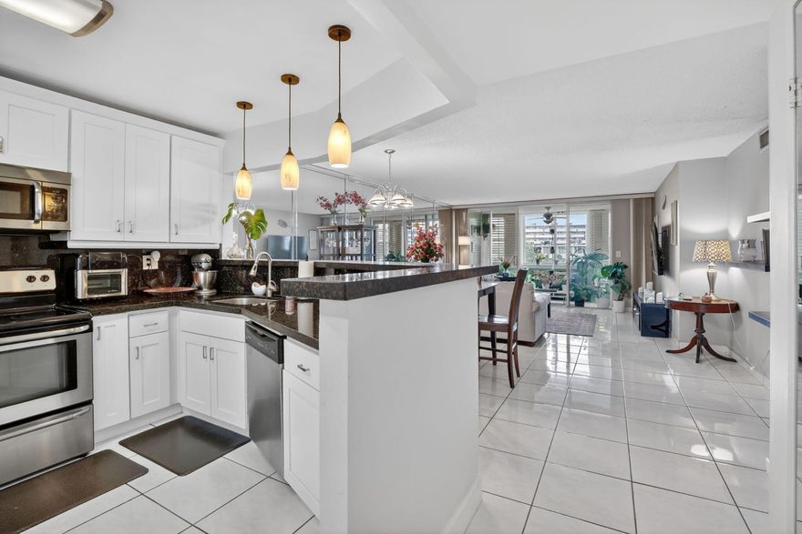 Move-in ready and one of the most updated 2/2 units in this 24-hour gated community! This beautifully maintained condo features new impact windows (2022) w/ transferable lifetime warranty, new A/C (2025), new roof (2025), and updated electrical panel (2021)—major improvements already completed for the next owner! The interior offers tile flooring throughout, granite countertops, stainless steel appliances, updated bathrooms, plantation shutters, and an in-unit washer and dryer for added convenience. The spacious primary suite includes two walk-in closets, providing excellent storage. Residents enjoy access to three pools within the complex, and the unit includes designated parking conveniently located near the elevator. Don't miss this rare opportunity to own a thoughtfully updated condo!