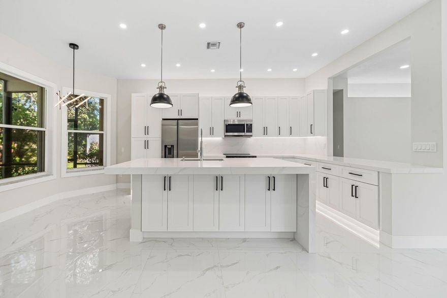 Welcome to 11431 Lanai Ln, located in the prestigious 55+ community of Valencia Isles.  This fully renovated single-family home has newer roof (2023). Entire exterior of home is being REPAINTED by the HOA in 2026. CHOOSE YOUR PAINT COLOR! Complete interior remodel from floor to ceiling. This home exemplifies modern elegance and comfort offering a luxurious living experience. This home features custom lighting with hi-hats throughout, LED mirrors in the bathrooms, European-imported porcelain tile flooring, and a bright, open-concept layout that seamlessly connects each living space. The kitchen is a true centerpiece, featuring sleek cabinetry, premium finishes, and an expansive quartz countertop as well as a quartz backsplash ideal for entertaining guests or enjoying casual meals.  The expansive primary suite features two large walk-in closets, a spa-inspired bathroom that includes dual vanities and a luxurious free-standing tub, as well as a modern tiled shower.   The 3rd bedroom is easily adaptable as a full bedroom, den, or home office space.   Enjoy complete peace of mind with major updates, ensuring efficiency, reliability, and worry-free ownership for many years to come.  In order to complete a truly modern style home, all of the walls and ceilings in this beautiful home have been fully skim-coated in order to remove all popcorn and knock down.  Valencia Isles offers a 24/7 manned gated entrance and a wealth of resort-style amenities, designed for an active and social lifestyle. The newly renovated clubhouse features a café/bistro, state-of-the-art fitness center, and a full calendar of events, shows, and activities. Outdoor amenities include a resort-style swimming pool, tennis courts, pickleball courts, shuffleboard, and a scenic pier overlooking the water. New additional pickleball courts coming soon!   Perfectly located near shopping, dining, and beautiful beaches, this stunning home offers the best of both luxury and leisure. Whether you're seeking a year-round residence or a seasonal retreat, 11431 Lanai Ln in Valencia Isles delivers unmatched style, comfort, and community in the heart of Boynton Beach.