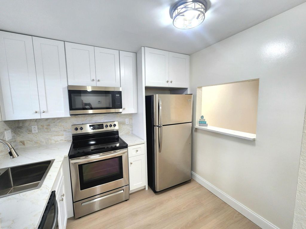 Photo of 4575 W Lucerne Lakes Blvd Blvd W #104, Lake Worth, FL 33467 (MLS # B26014446)