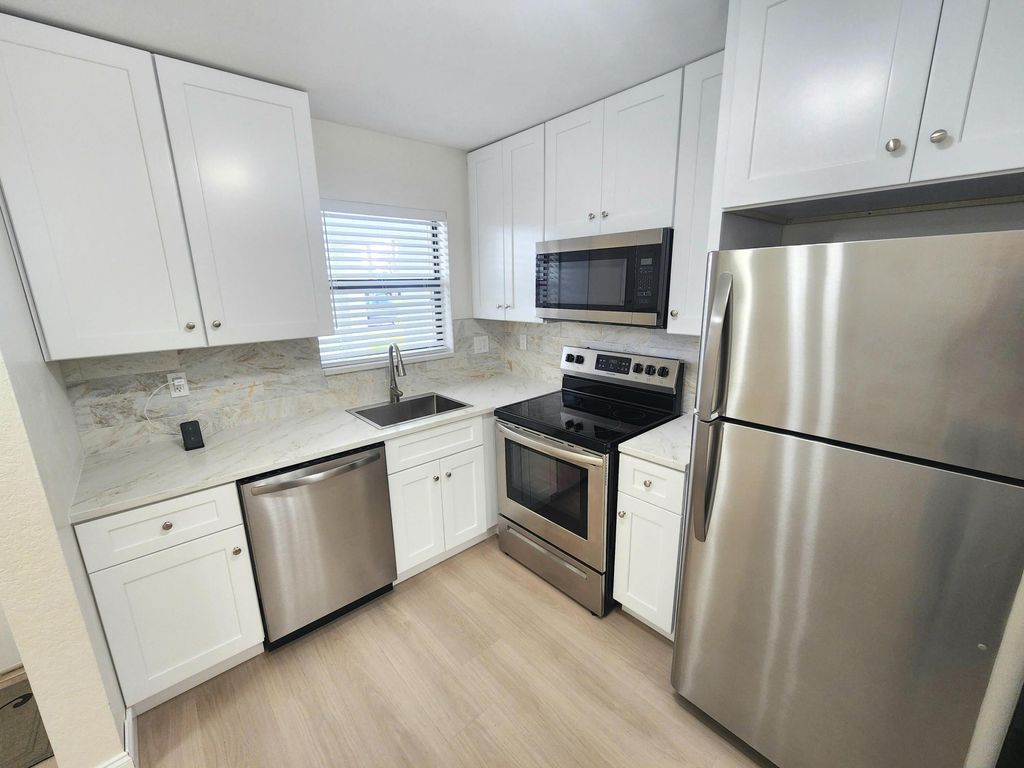 Photo of 4575 W Lucerne Lakes Blvd Blvd W #104, Lake Worth, FL 33467 (MLS # B26014446)