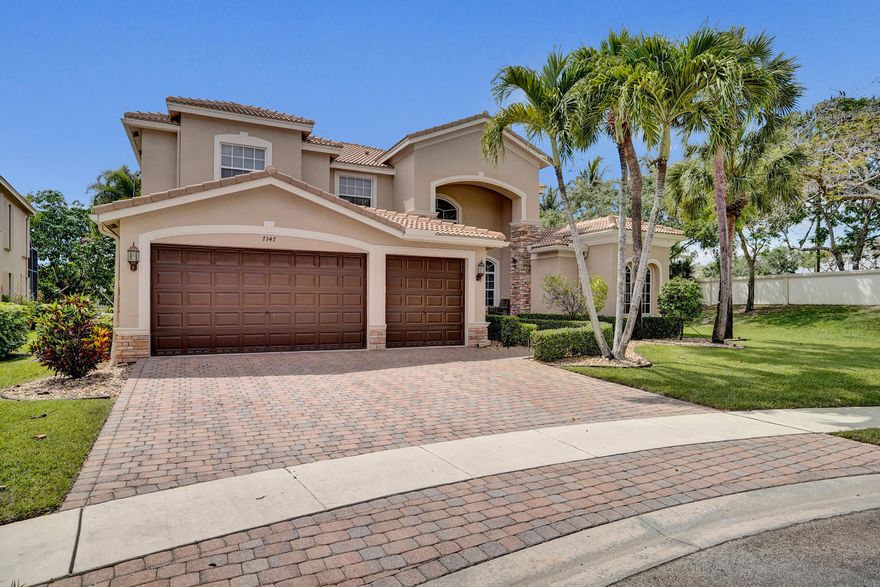 Breathtaking and VERY well-maintained Estate home in manicured neighborhood zoned for excellent schools. Step inside where abundant windows let natural sunlight pour in, Cathedral ceilings provide inspiring spaciousness and expansive pretty marble floors draw your attention to a real fireplace adorned with pretty white faux coral stone.  The family chef will love the expansive kitchen with top of the line stainless appliances. Also, the large loft gives kids of all ages access to the Theatre and provides plenty of room for pool and other game tables. The huge Master bedroom features his/hers closets with built-in storage leading to the large  bathroom framing a Roman tub.  Furthermore, across the downstairs, and if you desire, there's a bedroom that makes a great Mother-in-law suite.    Also, the (2) large upstairs kids' rooms are joined by a "Jack-n-Jill" bathroom AND off the hall there's another full bathroom. Enjoy the sunsets over a lakeview while lounging under an enclosed pool and hot tub  Additionally, you'll have peace of mind during storm season from the whole house generator, accordian shutters and front impact windows. Plus this luxurious home offers a newer roof (2021) and AC units (2024, 2025) and top-notch landscape lighting.  This home has it all!