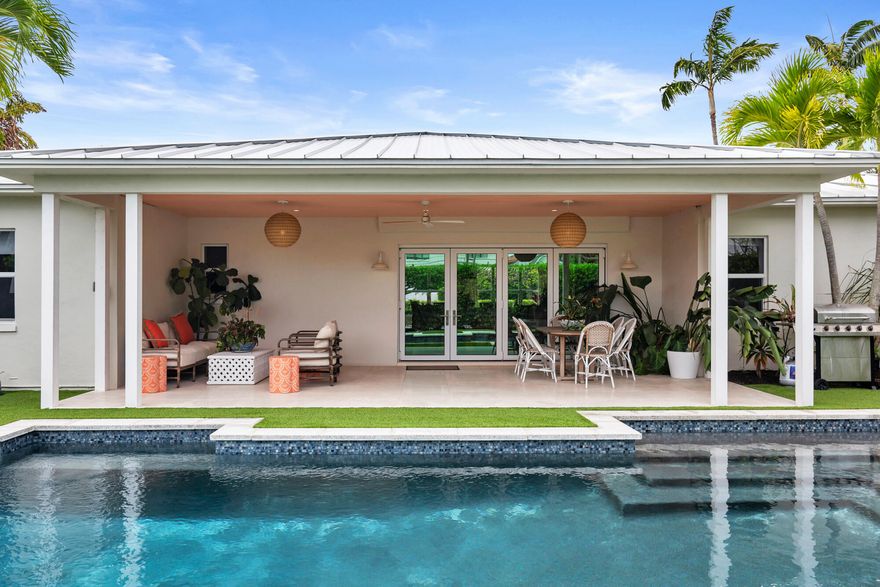 Tucked away on a coveted intracoastal block in SoSo, 225 Russlyn Drive is a beautifully renovated, move-in-ready retreat with 3 bedrooms and 3 bathrooms. Sitting on an oversized 10,890 SF lot stretching block-to-block, this property offers a sunlit front garden with endless curb appeal, along with a lush private backyard, large heated pool, and ample off-street parking including a 2-car garage. Inside, the foyer leads to a light-filled dining and living room that effortlessly blends indoor and outdoor living with nano sliding glass doors opening to an expansive covered outdoor loggia. The updated kitchen includes a charming breakfast nook, perfect for casual mornings, and large gas range, ice maker, and French door refrigerator ready for hosting larger gatherings. The desirable split floorplan provides a spacious primary bedroom and two guest suites, each with walk-in closets. With ample natural light and views of the lush gardens and sparkling pool from just about every corner, this home is an ideal West Palm Beach retreat. The east block of Russlyn Drive is the best of both worlds - the privacy and quiet of a cul-de-sac street with a dedicated easement to Flagler for easy access to the waterfront walking and biking path. Close to local beaches, Worth Avenue shopping, best in class restaurants, and top tier schools.