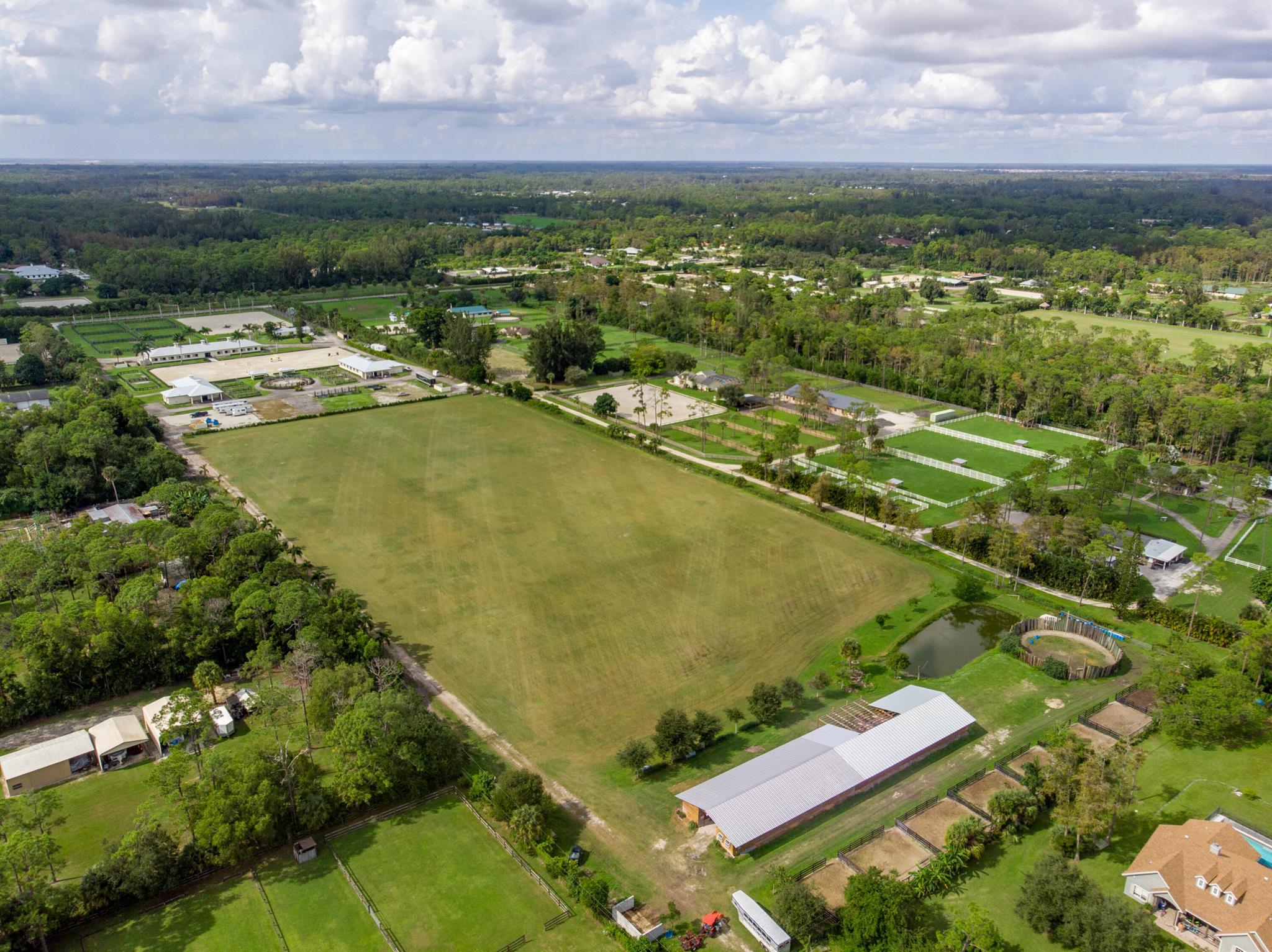 10 Acres with 24 stall Barn - located on the coveted F Road Equestrian Corridor leading directly to Wellington's World Class Equestrian Wonderland. Enjoy a rare lifestyle with plenty of room to build your Dream Estate. The immaculate, well maintained grassy field with irrigation is perfect for any equestrian discipline. The 24 stall Center Aisle Barn provides 24 12 x 12 stalls with water and electric to each stall, Office, Clubhouse, Feed Room & Tack Room. Amenities include Washer/Dryer, Electric Vehicle Charging Station and 1.5 bathrooms. Perimeter Exercise Track. No need to leave property. Zoned AG/RES. Easy access to Southern Blvd and minutes to shopping, fine dining, beaches, airport and turnpike. Shown by APPOINTMENT ONLY. Available for Seasonal Rental see RX-10733539