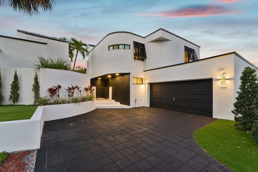 Discover the epitome of luxury living with this completely renovated, designer-inspired home offering a new seawall & dock (paid for but not yet complete), new roof, all new AC units, new impact glass windows, new tankless hot water heater and all new pool equipment. The kitchen is a chef's dream, complete with an island, an adjacent dining area for entertaining, & a hidden pantry. The ground-level primary bedroom is a sanctuary of comfort, boasting 10 foot ceilings, porcelain floors, wet bar,spacious walk-in closets, and secret entry to the pool.  Positioned with 80' of waterfrontage, and only minutes to the ocean, this is a boaters dream! Just minutes from Publix, Whole Foods, tons of restaurants.