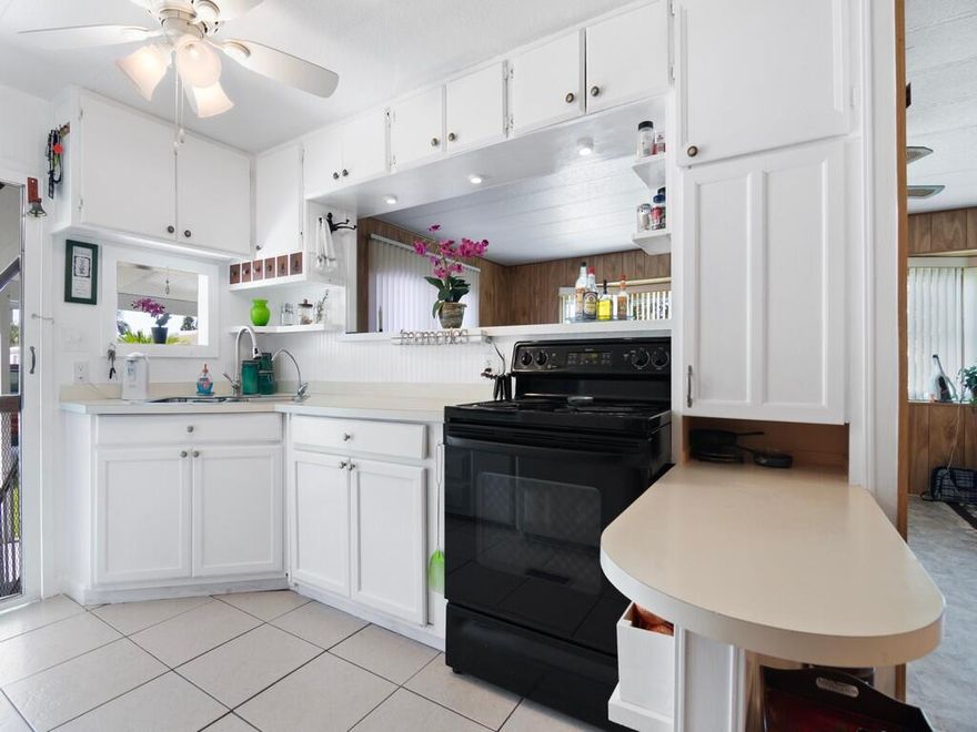 Is it finally your time to own a piece of paradise? Look no further! This spacious two  bedroom, two bath home is waiting for you.  This charming home has had the kitchen and both bathrooms updated! The extra long covered parking is great for company or your golf cart! After all, this home is in a very active 55+ community and has many amenities including pickle ball, bocci ball, pool tables, and many more activities plus it's very own boat ramp and dock on the St Lucie River!  And if worry free lifestyle is your idea of living this home has a newer A/C, a new water heater 2021, washer and dryer  2011, kitchen faucet 2013, fridge 2010, microwave 2007 New Florida room 2023, New sub floor living rm 2022, updated baths & Kitchen cabinets rebuilt in 2013. Schedule your showing today.