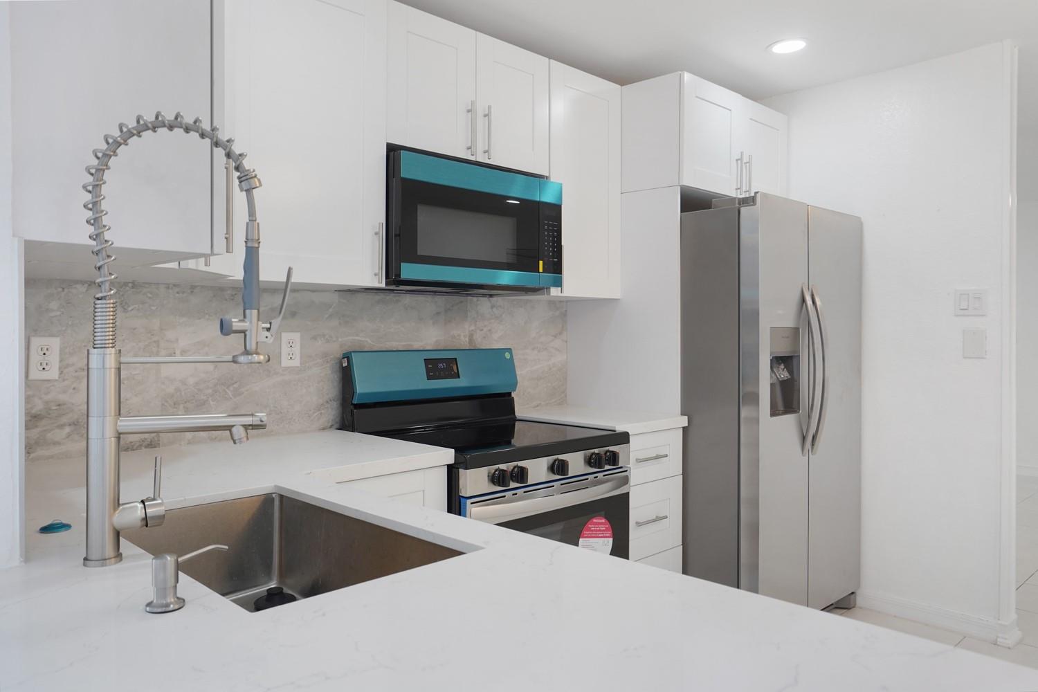 Welcome to your ALL AGE single family home in Mainlands of Tamarac Section 9. This beautifully renovated residence features a full brand new renovation. Stainless steel appliances, smooth ceilings (no popcorn), fresh interior paint, new flooring throughout, quartz countertops, marble backsplash, and more. Enjoy the newly renovated bathroom, as well as the overall contemporary touches during the remodel. Experience a fresh start in a welcoming neighborhood. Don't miss the opportunity to see this stunning home for yourself, and make it your very own.