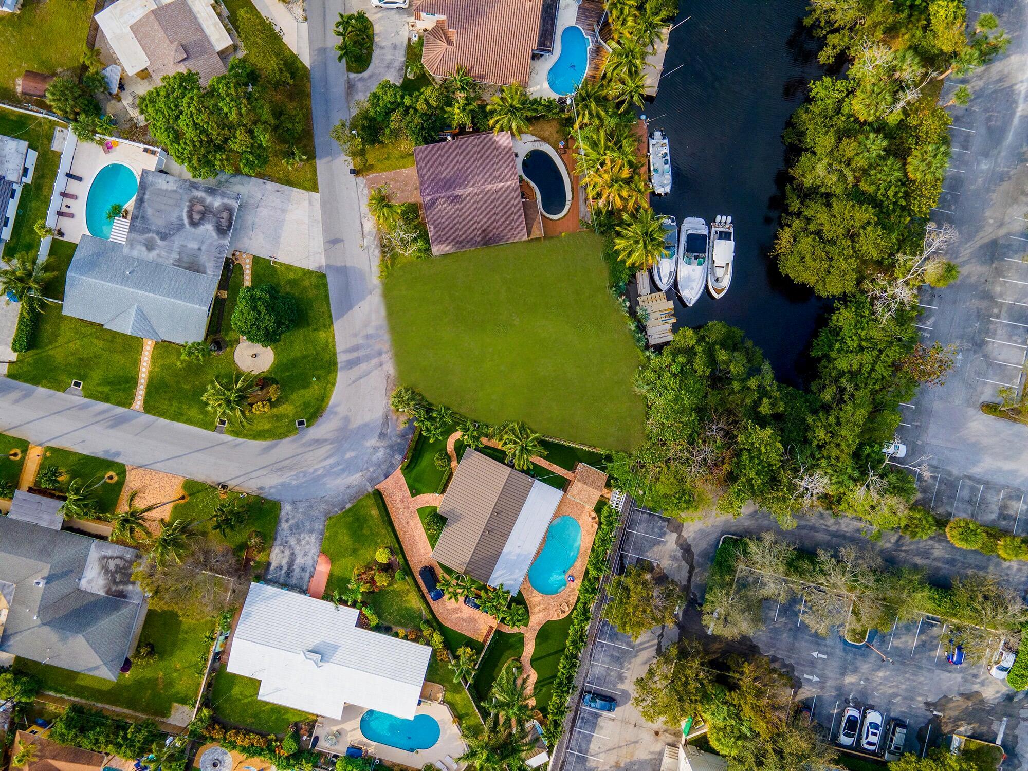 Have the luxury of designing your WATERFRONT sanctuary on this expansive 7,386 sqft lot, complete with 50 ft of pristine water frontage. Envision your very own private dock right in your backyard, where serene canal views meet direct access to Lake Boca and the ocean, navigable with ease via a single high fixed bridge.(N Federal, clearance is high tide 14ft low tide 17ft). Nestled in the peaceful Deerfield Beach community, this rare gem of a lot is just a stone's throw from sandy beaches, Pioneer Park, and convenient boat launching facilities. Ready for you to bring your dream home to life in this idyllic setting. Seller makes no representations on digitized lot boundaries, Buyer shall conduct due diligence during inspection period.