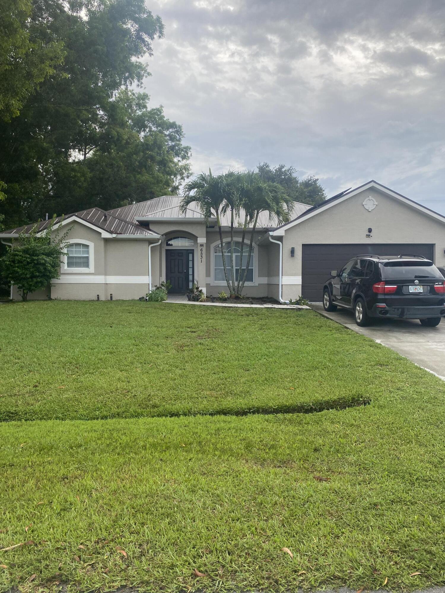 Prime Location! Look no further! Priced to sell! Welcome to this beautifully maintained 4-bedroom, 3 full bath, with a den/office and 2-car garage single-family home offering 2,055 sf under air. Featuring a master bedroom with 2 walk-in closets, newer metal roof installed in 2023, Water Heater 2025, and solar panels that will be fully paid off, at closing. This home combines long-term savings with peace of mind. Inside, you'll find a thoughtful layout perfect for families or multi-generational living. Step outside and enjoy the home's proximity to a local park, just steps away, featuring a tot lot and full basketball court. ideal for active lifestyles and family fun.Don't miss the chance to own this energy-efficient, move-in-ready home in a desirable location!