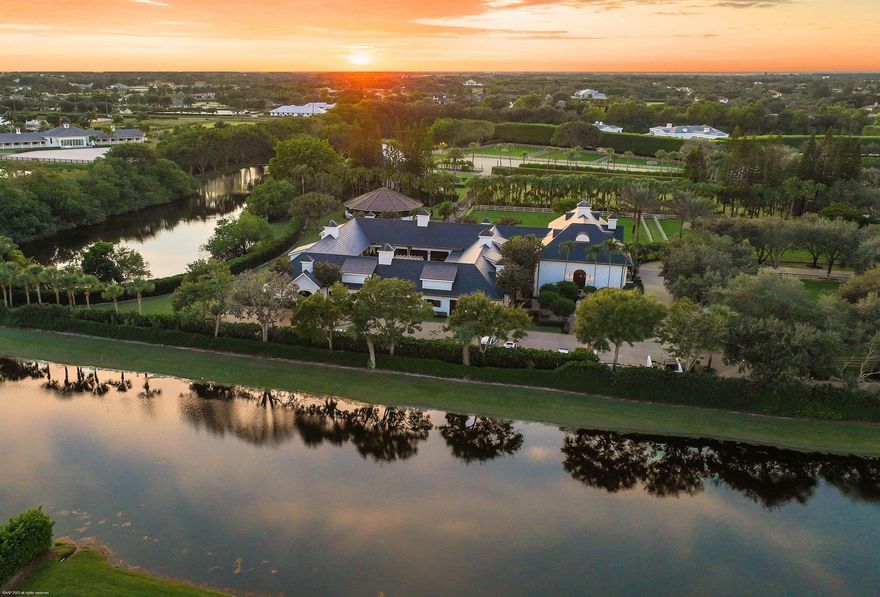 This prestigious property is one of the largest farms in Grand Prix Village. A total of 3 lots covering over 14 acres with lush landscaping throughout, creates the perfect private oasis, right around the corner from the horse show. All roofs were replaced with gorgeous black, slate look tile in 2023. All the buildings were painted in a fresh white color that pops with the green landscape, and handmade cobblestone driveways and aisles. Plenty of room for all your horses with two barns, totaling 28 stalls. The main barn is centered around a beautiful courtyard and with 4 new grooming areas added to the previously existing 3 wash stalls, all the daily hustle and bustle is kept together, leaving the 20 refinished Loddon stalls quiet and peaceful for the horses to relax in. The feed room