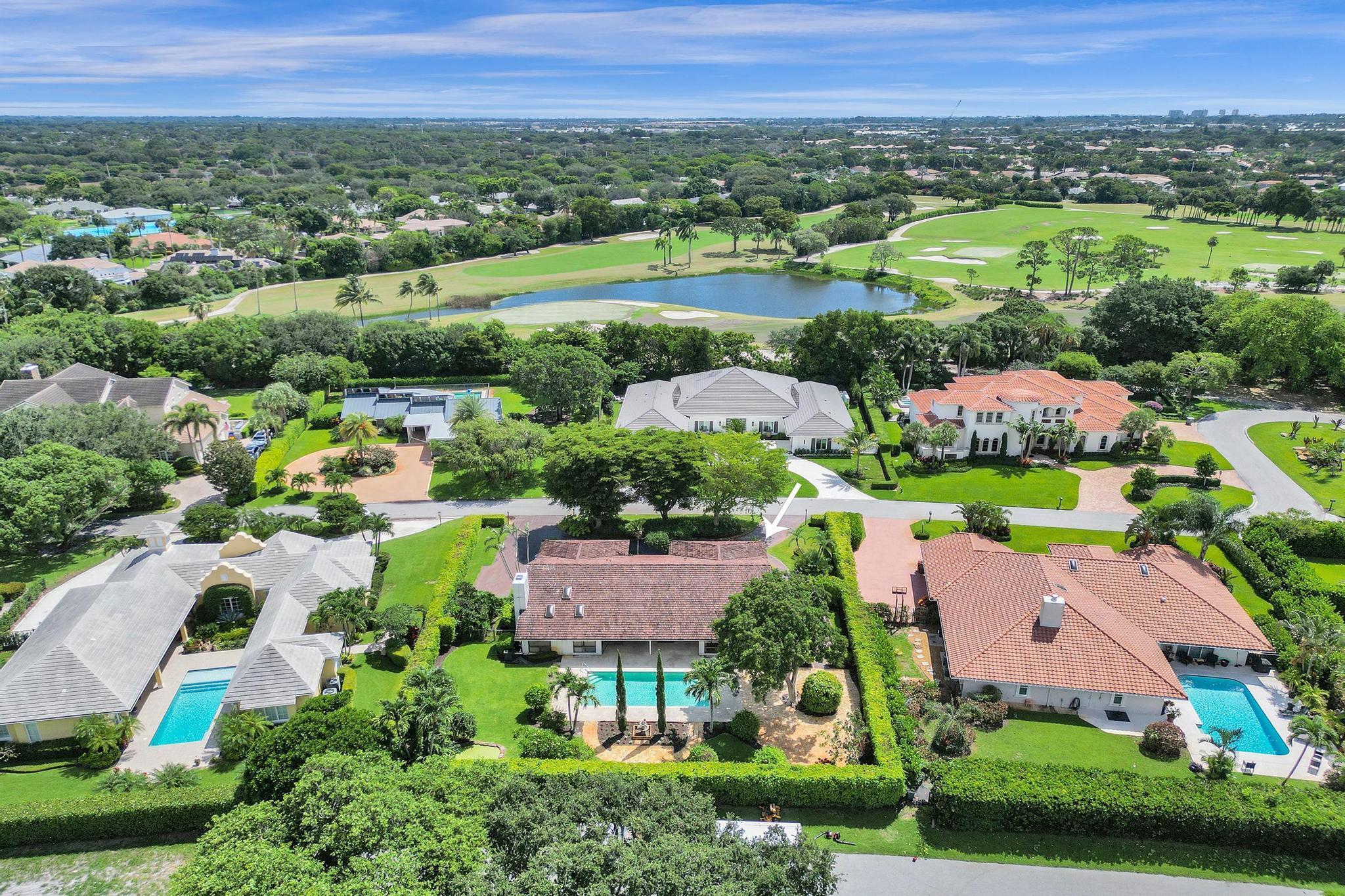 Situated on a rare oversized lot surrounded by multi-million dollar estates, this 4-bedroom, 2 full bath + 2 half bath residence offers a once-in-a-generation opportunity in the prestigious, gated Pine Tree community--Boynton Beach's best-kept secret with a Palm Beach Island feel, without the island price.Owned by the original family, the home is brimming with character, including a formal dining room, two separate living areas, a cozy fireplace, and a large updated laundry room with ample storage. The back of the home features full-impact sliders that overlook a lush, whimsical yard filled with mature trees and a sprawling resort-style pool--an entertainer's dream with a large covered patio and plenty of space to host unforgettable gatherings.While the home needs work, it's