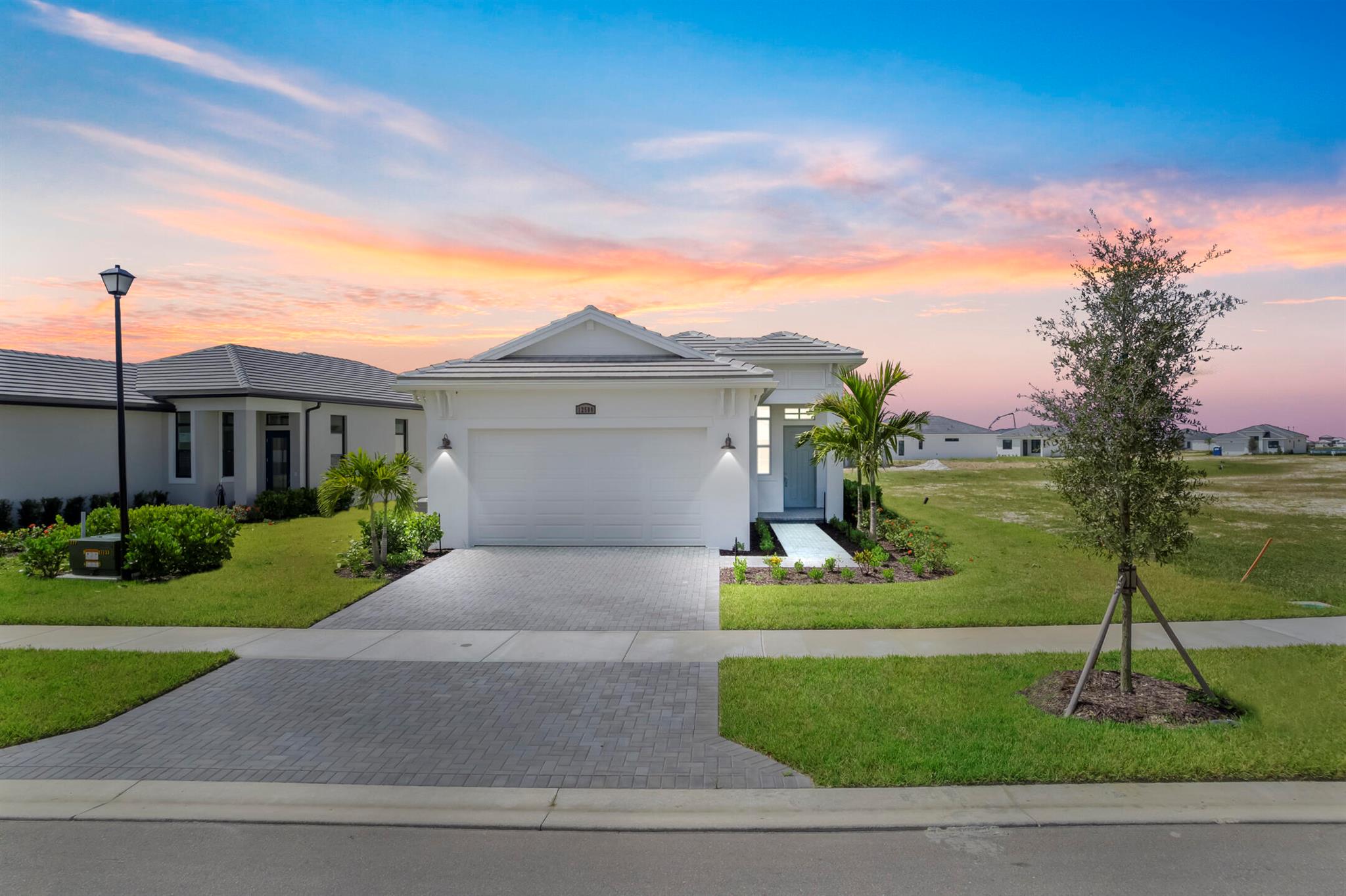 **New Construction** Ready to move in! Enjoy resort-style living at PGA Village Verano with daily events, activities, and lifestyle amenities blending relaxation with recreation just steps from your front door. This thoughtfully designed 3-bedroom, 2-bath Caroline home includes a versatile flex space perfect for a home office, hobby room, or guest area, and extended lanai.The open concept layout features a seamless flow from the kitchen to the living and dining areas, ideal for modern living. Set on an oversized lot, there's plenty of outdoor space for entertaining or future customization.