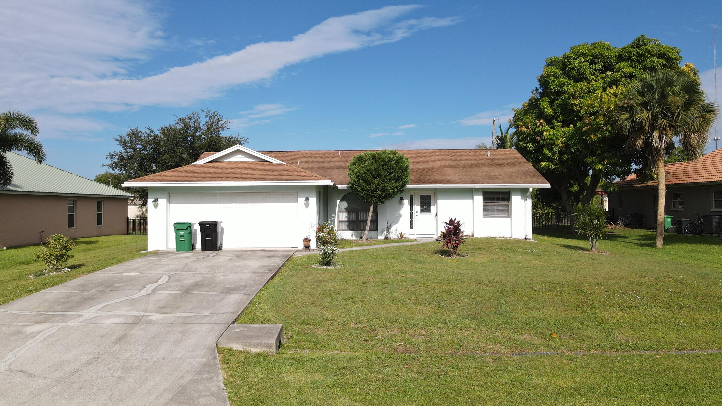 This gem on Florida's Treasure Coast offers strong curb appeal on a .24-acre lot, just minutes from beaches, shopping, dining, and highways. Mostly move-in ready with a BRAND NEW hot water heater, BRAND NEW A/C, and a screened lanai, it invites your creative touch with your own updates to the kitchen and roof to make it your own. A perfect blend of comfort, location, and opportunity. Don't miss your chance to enjoy beautiful sunsets from the comfort of your new home--schedule your private showing today!