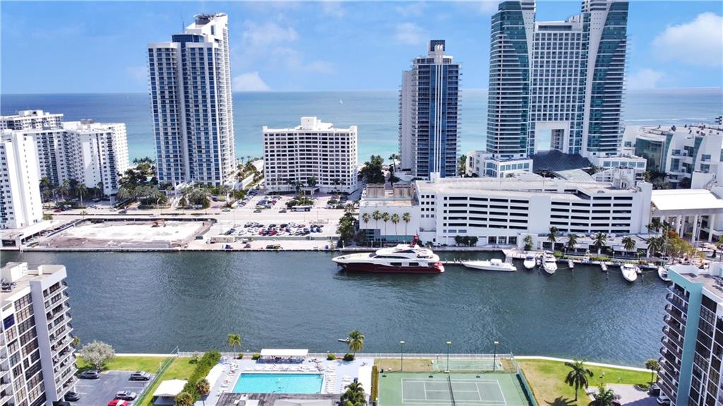 Back on the market! Buyer financing fell through. Snow bird or live year round ! One bedroom with a den easily can convert to a two bedroom ($3K- 5k to add a wall) You will not find another unit in this building, decorated and upgraded with a beautiful partial water view and a great view of the Guitar Hotel and 13 foot ceilings fully renovated with a Modern touch! A designer chefs kitchen with a tv all open to the dining room with floor to ceiling windows throughout the whole unit . Almost Every wall has a decorative detail touch that will stand out like no other ! Colorful and full of design ! New and bold light fixtures throughout even a chandelier in the master walk in closet !