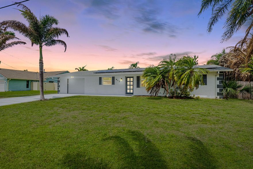 Waterfront living at its best! Enjoy ocean access from your private wide canal with seawall, 60' dock, and 12,000 lb boat lift—perfect for boating enthusiasts. This immaculate CBS construction 3BR/2BA home sits on an oversized 100x150' lot and features a dual-access 1.5-car garage. Freshly painted inside and out, with impact glass windows, a 2021 roof, 2022 water heater, and whole house solar system for efficiency and peace of mind. Relax in the screened lanai overlooking a sparkling 32x16 gunite pool, covered patio, and serene canal views. Inside offers tile flooring in main areas, laminate in select bedrooms, and dining room pocket sliders to the pool. Conveniently located near River Park Marina and its public boat launch. Room to expand—schedule your private showing today!