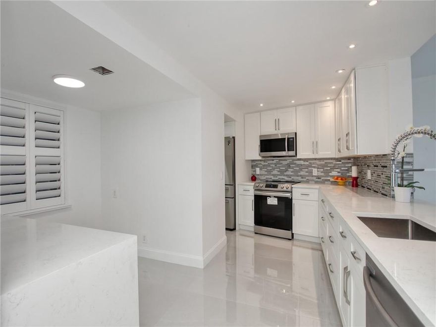 **ABSOLUTELY STUNNING!!!** MODERN TOTALLY RENOVATED 2-Bed, 2-Bath KING (B-7 floor plan) condo with awesome view of the Oaks golf course. Property features a HUGE KITCHEN with white Shaker cabinets, recessed lighting, Quartz countertops, STAINLESS STEEL appliances, eat-in kitchen area and separate laundry room to fit FULL SIZE washer and dryer. Large, imported porcelain tile flooring throughout. Plantation shutters. IMPACT SLIDER AND WINDOWS. NEW Electrical panel, new FIRE SPRINKLERS, high end ceiling fans, extra storage. Cable & internet included in condo fee. PALM-AIRE is a golf community with easy access to 2 major highways, close to shopping, banks, the Isle Casino and restaurants. A short ride to Fort Lauderdale airport and the beaches.  ALL AGES are welcome. BRING YOUR BUYERS! Impact windows and slider to be installed on June 15th.
