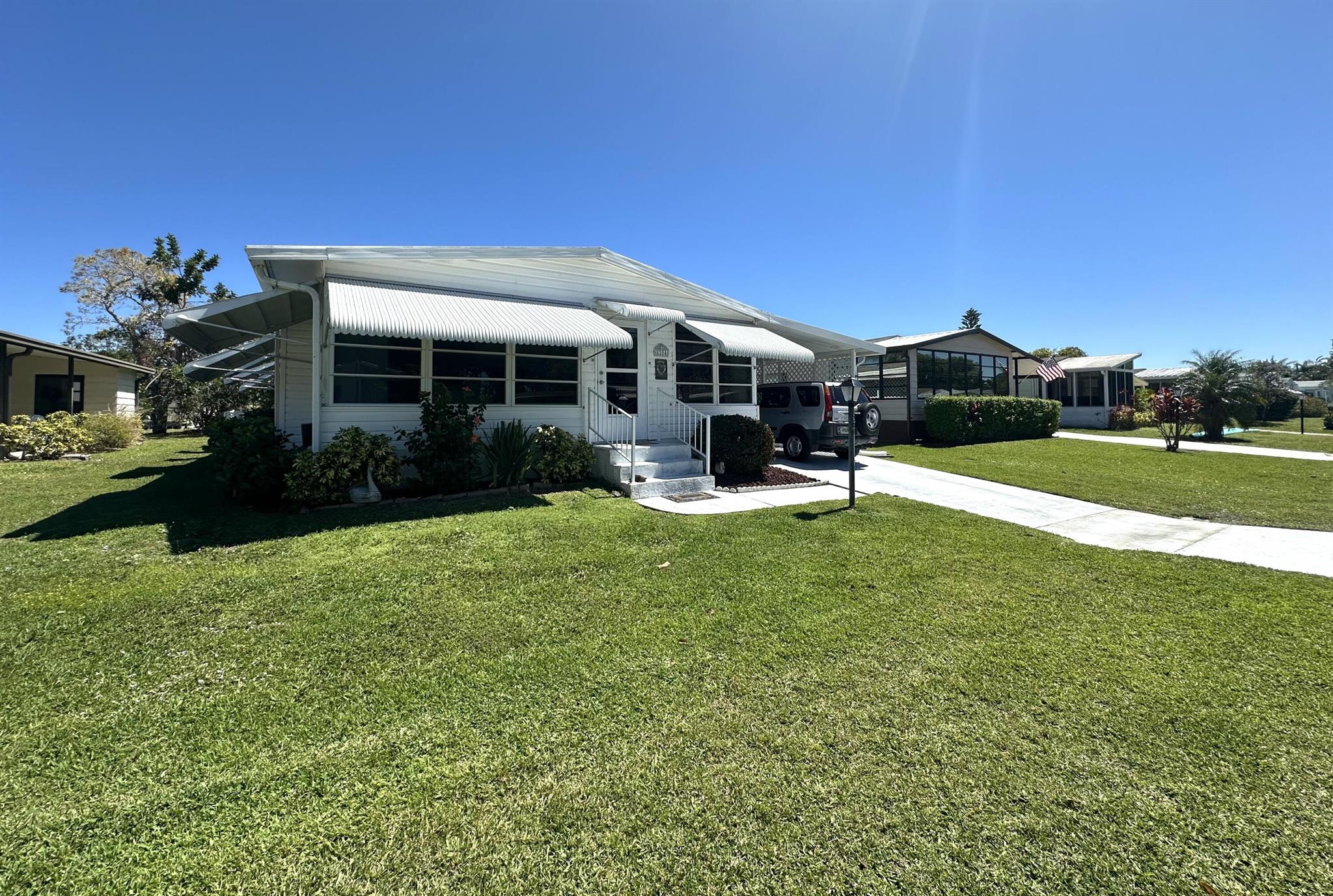 Own Your Land. Charming 2 bedroom, 2 bath home, fully furnished, turnkey and ready for you to start living the lifestyle so many desire in the Savanna Club 55+ community. Home is light and bright through out with laminate and tiled flooring, updated appliances, 10 x 24 enclosed, glass lanai, 11 x 16 storage shed and minutes to beaches, shopping, dining and medical services. Savanna Club offers 2 clubhouses, a recreation center, a 10,000 theatre, 3 pools, spas, fitness centers, golf, onsite restaurant and more...All measurements approximate, buyer to verify.