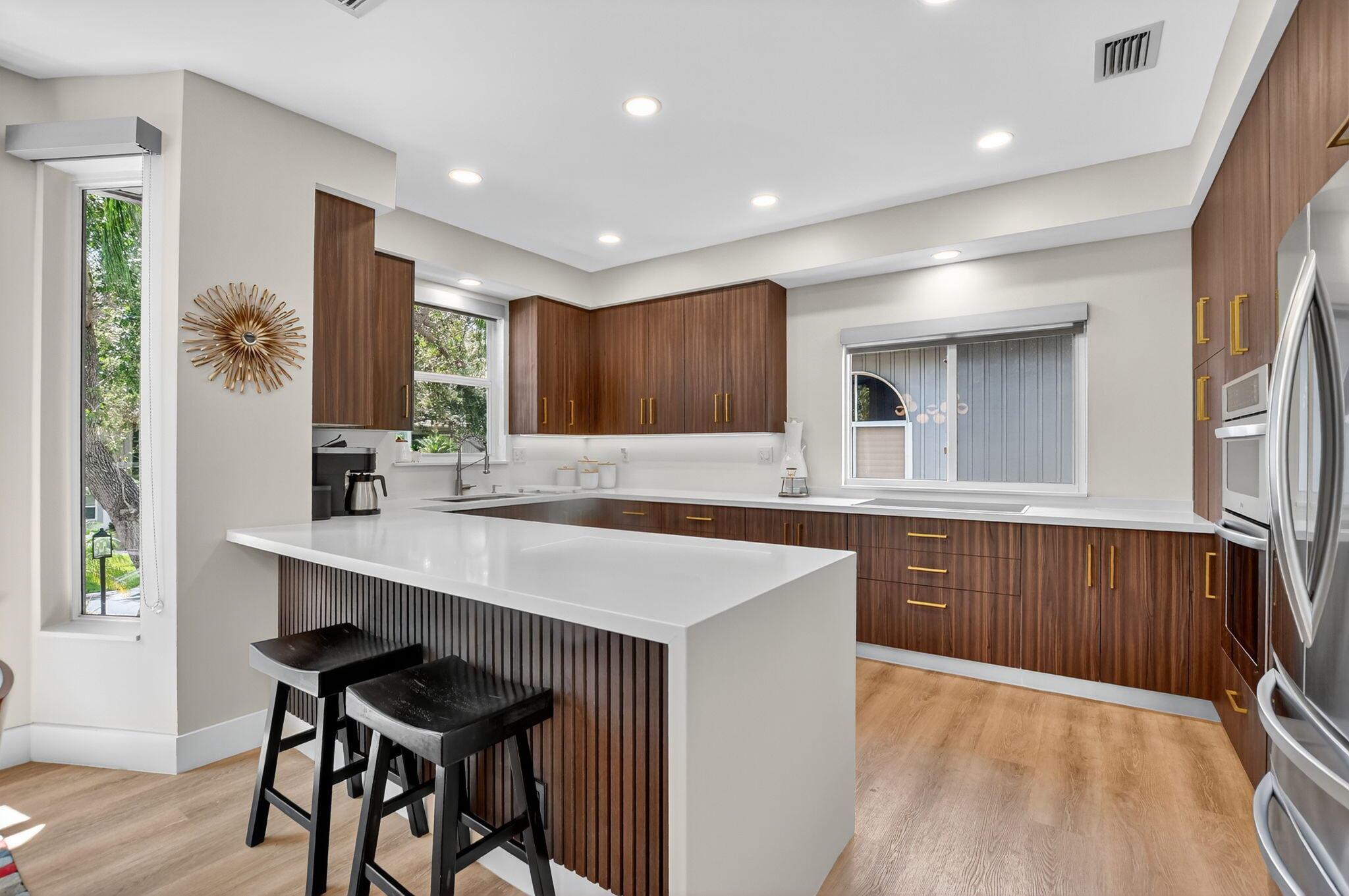 Fully renovated, move-in-ready, custom apartment in the Cove. Property has been reconfigured to have a better flow. Impact windows throughout, vaulted ceilings, designer finishes. Only steps from clubhouses. ~ Imagine life inside the Nation's #1 Private Residential Country Club Lifestyle offering resort-style living. Conveniently located less than 10 minutes from downtown Boca Raton. PLAY our 4 Golf courses, 27 Tennis courts and 14 Pickleball courts; SHOP our retail store, golf and tennis pro shops, DINE in our 8 dining venues. Spend the day RELAXING at our 5-star fitness center, pool, spa and salon. ENJOY endless activities in over 450,000 sq. ft. of exceptional amenities & stellar service. Mandatory Joining Fee: $150,000, BWMA Capital Contribution: $10,000, Annual Social Dues: $24,454.