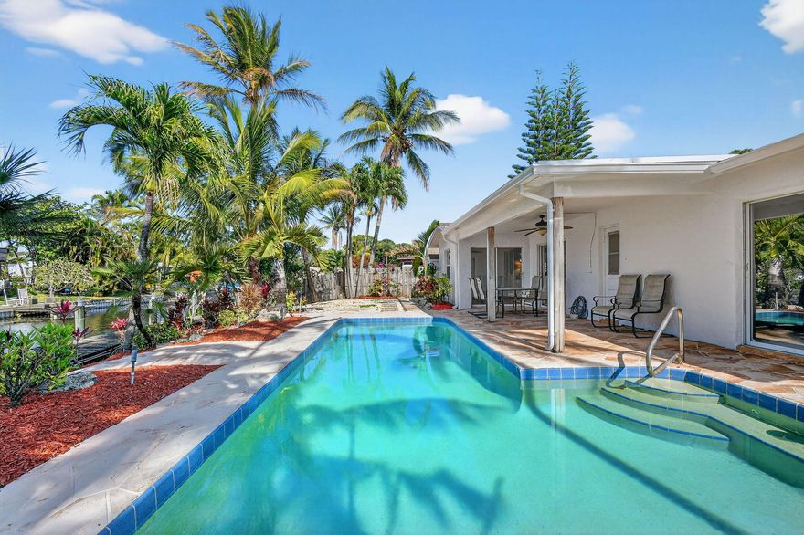 This waterfront home on the canal features a boat lift and a jet ski lift. The three-bedroom, two-bathroom house has been freshly painted inside and out, with new carpeting in the bedrooms. Upon entry, you see tropical landscaping, an inviting pool, the dock, and the canal. The waterway provides access to Lake Ida, Lake Osborne, and beyond. The extended driveway offers plenty of room for guests, RVs, or additional toys. The best part is that there is no HOA. The water heater is new. Public records show reroof in 2020. The dock is about 68 feet long and has electricity.