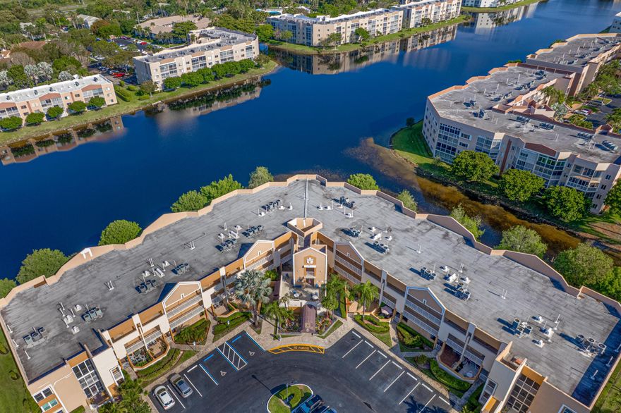 Gorgeous condo on the first floor with over 1800 sq ft overlooking the lake.   This unit features a renovated kitchen and master bathroom. Newer AC, hurricane srorm shutters, front and back patio, parking space is near the front door and the view is spectacular