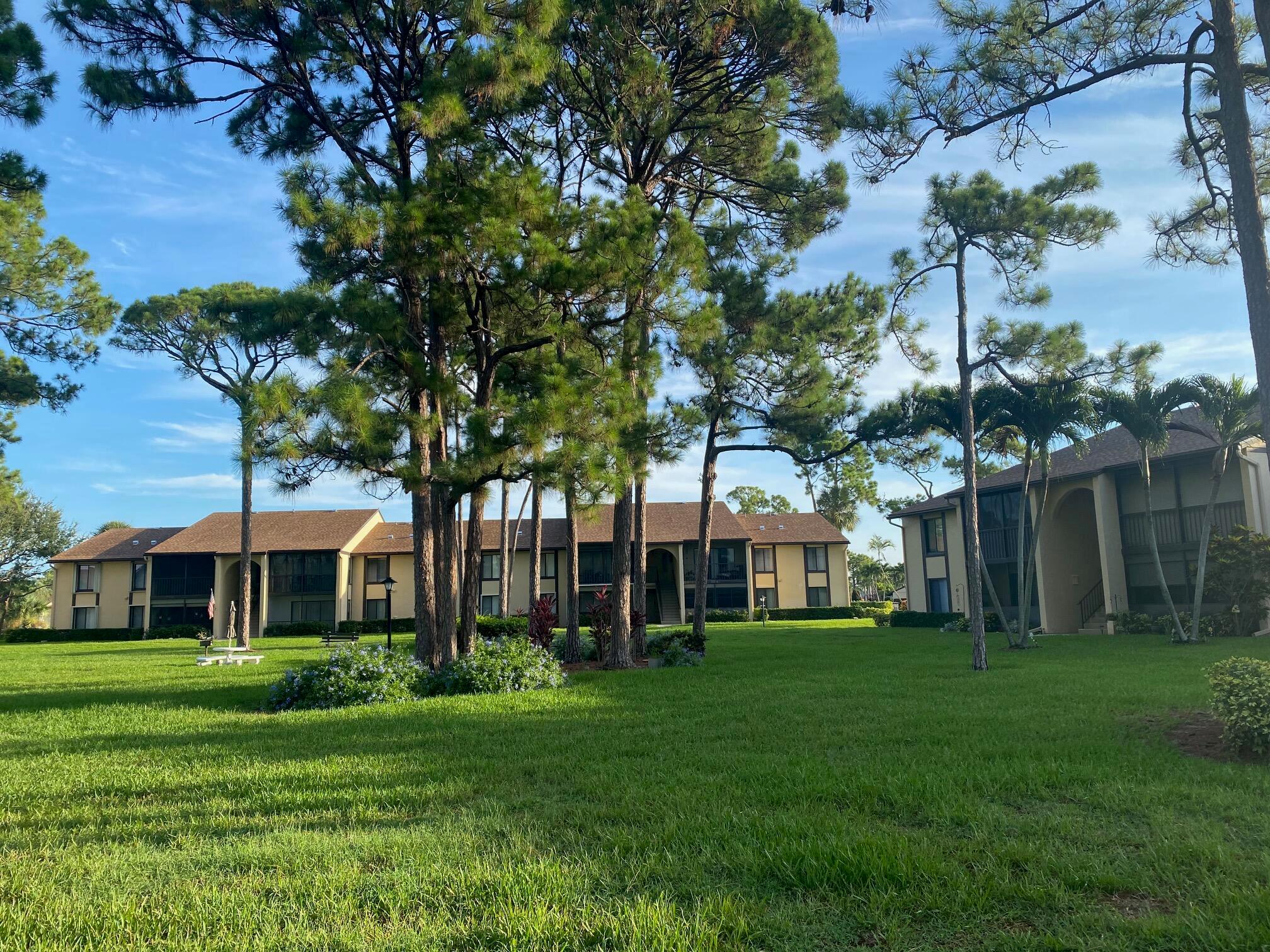 COZY CORNER CONDO WITH TRANQUIL GARDEN VIEWS UNDER A CANOPY OF PINE TREES. 2nd floor 2 Bedroom 2 full bath unit.Covered screened patio facing tranquil garden. Condo offers an eat in kitchen plus separate dining area. Spacious laundry room with full size washer and dryer. Corner unit provides a light and bright environment. Active adult community is centrally located and is still a hidden gem with fun filled camaraderie pickleball, tennis and bocce sessions. Olympic size heated swimming pool and separate spa. One owner must be 55 other occupant can be 35. One pet allowed weight restricted. No lease until rental ratio is below 20%. 15 minutes to the beach or PBI airport and close to any restaurants and shopping you woud want.
