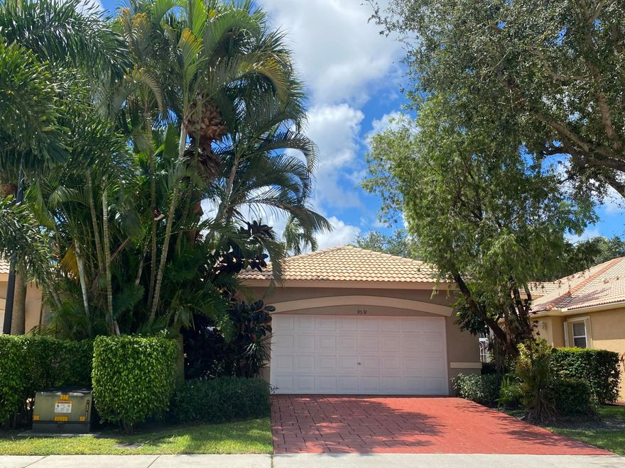 This bright and spacious home boasts soaring ceilings and a nicely updated 3-bedroom, 2-bathroom villa in 55+Palm West Community. This beautiful unit which was  the builder model home has a lot to offers an open floor plan, an abundance of natural light, crown molding, a large open space for entertaining. The private screened patio offers the perfect spot to relax. The master suite has a large walk-in closet with built-ins and a large soaking tub. Spacious second and third bedrooms, the third bedroom is currently being used as an office. The kitchen has beautiful granite counters. New A/C less than a year old. Palm Isles West offers a vibrant community with a 54,000-square-foot multi-million dollar renovated Clubhouse.  Pickleball, tennis courts, four swimming pools, and an indoor pool, ensuring ample year-round activities. The onsite café serves breakfast and lunch seven days a week, providing convenient dining options. The HOA maintains the exterior of the homes, including regular painting, allowing you to enjoy peace of mind while preserving the community's aesthetic appeal. Other included services are a basic alarm system, pest control, and landscaping, ensuring your home stays in pristine condition. Residents also enjoy basic digital cable, as well as high-speed internet. Sidewalks and gated security make Palm Isles West offer a perfect blend of comfort and convenience. Don't miss the opportunity to make this exceptional property your new home!