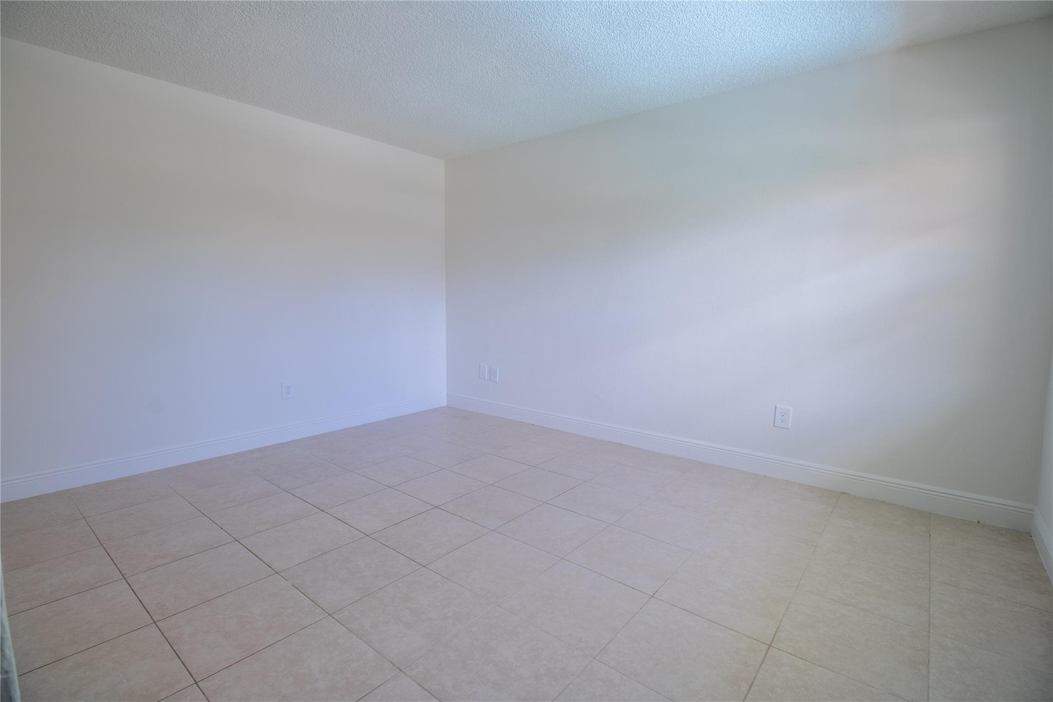 Nestled on the second floor, this 2-bedroom, 1-bathroom apartment boasts a fully tiled interior and an array of included services: water, trash removal, monthly pest control, landscaping, and pool maintenance. With the added comfort of central A/C, enjoy a relaxing environment all year round. Benefit from the convenience of an assigned parking space and on-site laundry facilities, alongside the delight of a beautiful on-site pool.