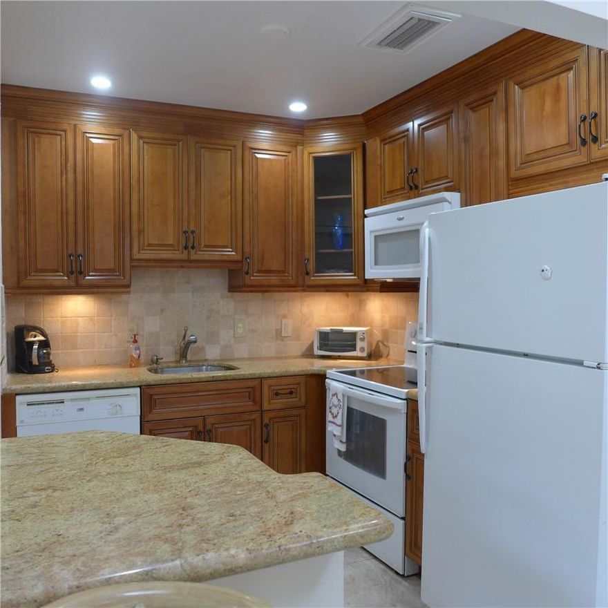 Spacious 2 bedroom 2 bath single family home in Natura with a one car garage..Updated kitchen and baths with wood cabinetry and granite..Family room with door to patio..Natura is a 55+ active community..