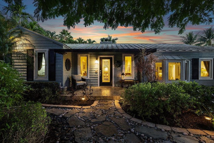 Tucked behind an arched gate on one of Palm Trail's most coveted streets - just two blocks from vibrant Atlantic Avenue and only steps from the Intracoastal - this charming single-story residence with attached guest house sits on a beautifully landscaped lot just shy of 14,000 square feet (approximately 100' x 140'). This is an exceptional offering in the heart of Delray Beach.
Surrounded by lush, storybook gardens, the property offers a true sense of retreat with winding flagstone paths and mature tropical plantings. A meandering stone walkway leads to the main entrance and a well-planned split floor plan featuring two spacious primary suites - one with an oversized dressing room/nursery - and a versatile third bedroom ideal as a home office or guest room. Inside, a welcoming entry foyer opens to a warm and inviting living space, highlighted by a wood-burning fireplace and a well-appointed kitchen with generous prep space and storage.

Step outdoors to discover the true magic of this home: tranquil garden pathways, a large swimming pool, and a cozy fire pit tucked beneath the palms. The home is perfect for entertaining or relaxing under the stars. The expansive lot offers rare breathing room, multiple outdoor gathering areas, and complete privacy.

Completing the property is a charming attached guest house with its own covered patio, kitchenette, and full bath - ideal for extended stays, guests, or use as a creative studio.

Located on NE 2nd Street - a quiet, dead-end lane with virtually no through traffic - this distinctive property offers the best of both worlds: secluded, peaceful living just a short stroll from Delray's renowned dining, shopping, and beachfront lifestyle.