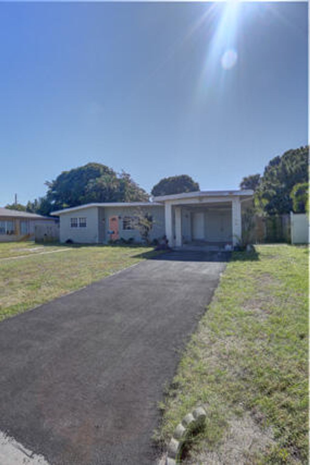 Photo of 328 E Jasmine Drive, Lake Park, FL 33403 (MLS # R11135049)