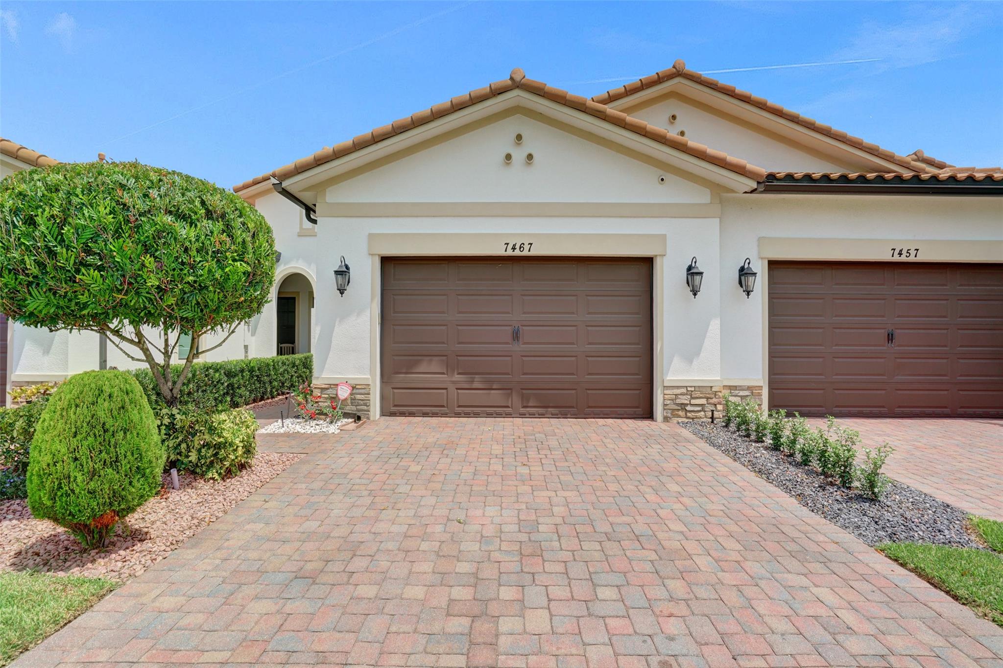 Stunning upgraded home in the desirable gated community, The Falls at Parkland, with $15K landscaping and extended private patio. Interior features brand new porcelain floors, fresh Benjamin Moore Regal Select paint, and a custom stone wall with fireplace. Upgrades include plantation shutters with blackout shades in master, built-out closets and pantries, upgraded laundry, kitchen backsplash, master shower, guest bath with porcelain wall, mirror with 3-tone lighting/defogger, and sliding bath doors. Enjoy Sonos sound with premium speakers, doubled ceiling lighting, whole-house water filtration, Trane XV variable-speed A/C, camera system, and insulated garage with epoxy floors and attic insulation. Conveniently located next to guest parking.