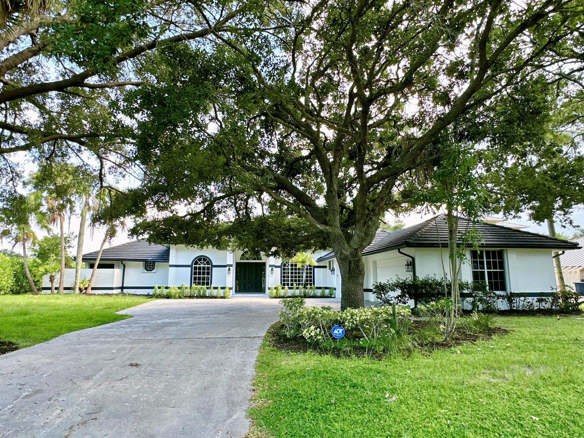 Located in the heart of Jupiter, this beautifully renovated single-family home sits on a generous half-acre lot just minutes from everything you need -- beaches, shopping, dining, and top-rated schools. Boasting 4 spacious bedrooms, 3 full bathrooms, and over 3,100 square feet of living space, this home offers an open and inviting floor plan ideal for modern living. Enjoy brand-new flooring throughout, a completely updated kitchen with stainless steel appliances, and stylishly redesigned bathrooms. The separate formal dining room is perfect for entertaining, while the cozy breakfast nook offers serene views of the expansive backyard. With plenty of room to host family gatherings and special occasions, this move-in-ready home is a rare Jupiter gem!