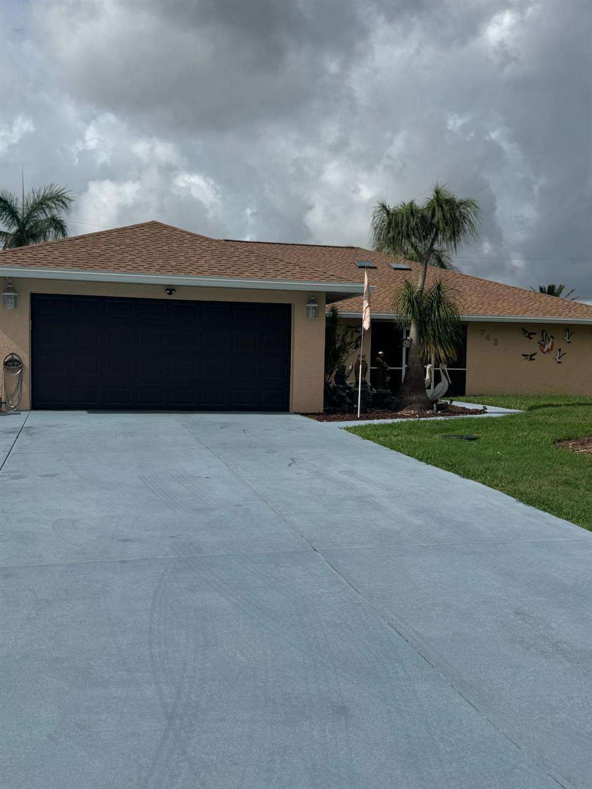This original 4 bedroom home (now flex room) underwent interior and exterior renovations in 2019 and 2025. New paint, new roof and gutters, remote controlled skylights, extra hurricane straps and blown in insulation, newer water htr, luxury vinyl plank flooring. Kitchen cabinet with soft close doors/drawer and roll out trays, 7 ft island with granite counter tops thru-out, 9 & 7 ft pantries, copper/bronze faucet, pot filler, pendant lights, extra lrg farmhouse sink and new appliances. Lrg pass thru window over the sink convenient to the gorgeous lanai, sliders from living to lanai that pocket, new tile floor and tongue in groove ceiling. Custom bar counter top and shelving make the ideal party zone. Generac generator, buried propane tank. Lrg renovated pool with cool deck and caretaker
