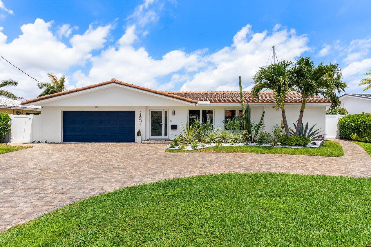 WOW!!! This home is stunning, completely updated with a 7 year old roof, impact windows and doors, newer A/C unit, brand new pool equipment for your saltwater pool, high end appliances, the list goes on! For those boat lovers - this move-in-ready home has 80' of waterfront, only 5 houses down from the Intracoastal with a private dock allowing for a 65' boat and has a 15,000-pound boat lift.The heart of the home is a chef's dream kitchen, boasting a massive 10' x 5' island, top-of-the-line appliances, an induction stove, double ovens, and pull-out drawers for ultimate convenience. A reverse osmosis system in the kitchen and a whole-house water filtration system ensure clean, fresh water throughout.