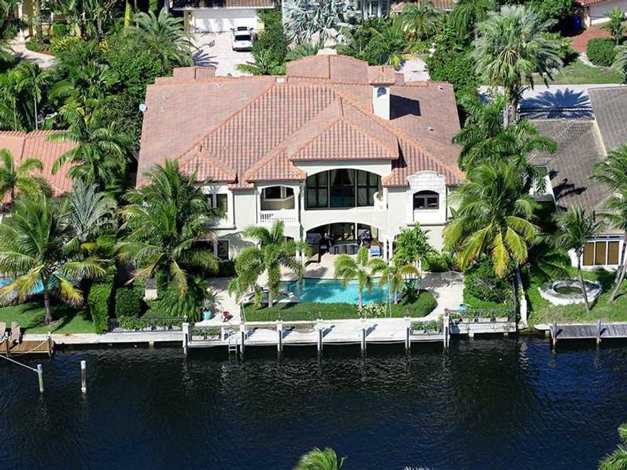 This generously sized residence of 9,285+/- total square feet offers seven bedrooms, eight and a-half baths, laundry rooms on both levels, and a three-bay garage.  Special amenities include impact-rated windows, a mahogany-paneled elevator, central vacuum system, and four-zone air conditioning.  Creamy marble floors flow through most of the main living spaces.