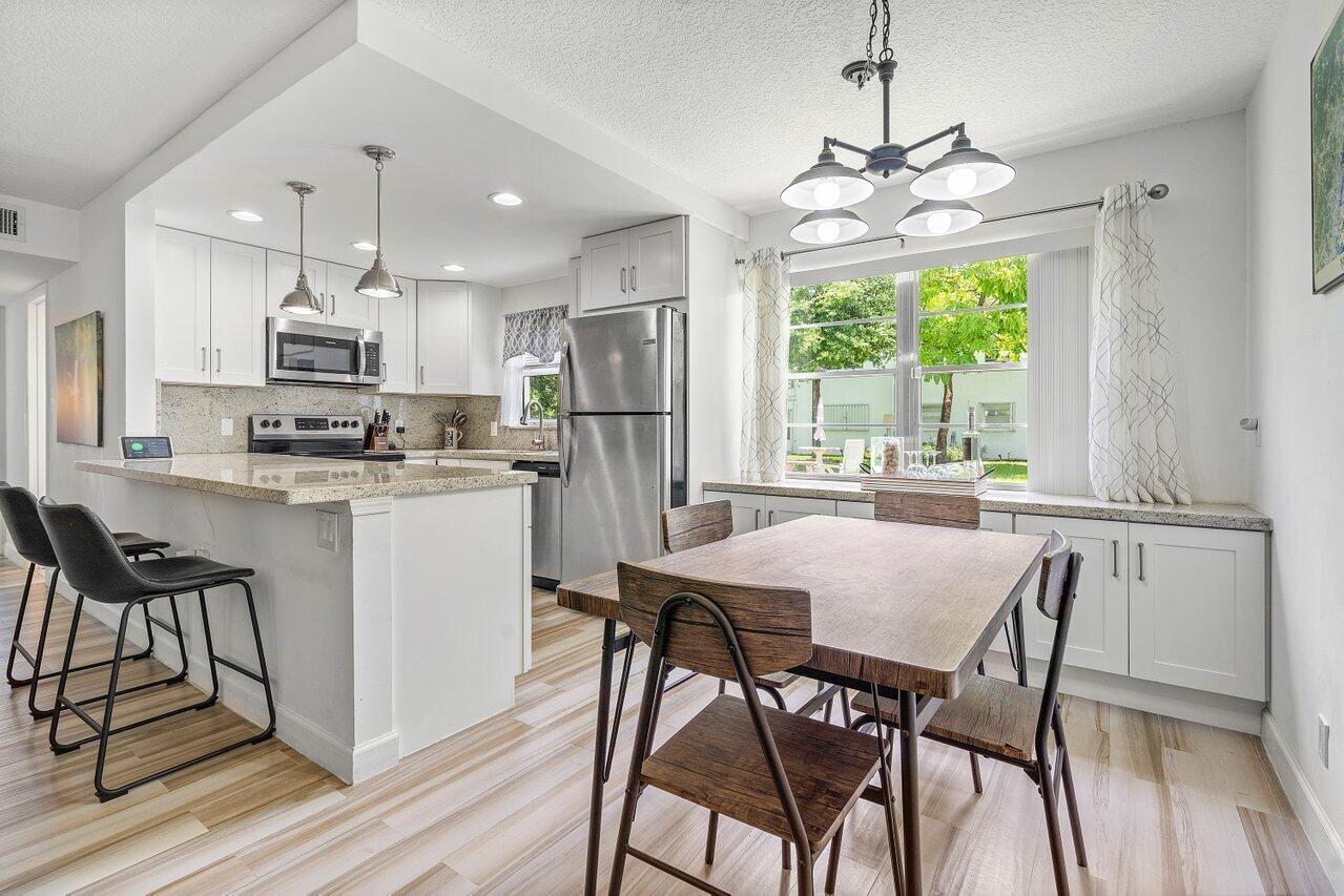Brand new Roof. Well managed building. Beautiful and pristine 2 bedroom and 1.5 bath ground floor corner unit located in Century Village East just a few steps from the Newport pool. Fully remodeled with permits in 2020. Open kitchen concept with white shaker cabinets with soft close doors, stainless-steel appliances, granite countertops and full backsplash. Top of the line wood-look ceramic flooring. Painted with elegant and neutral high-end paint. No Popcorn on ceilings. Primary room has large walk-in closet with custom built-ins. Both bathrooms have been fully updated with beautiful lighting, tile, and vanities. Walk out to your private enclosed Patio from either bedroom through sliding glass doors