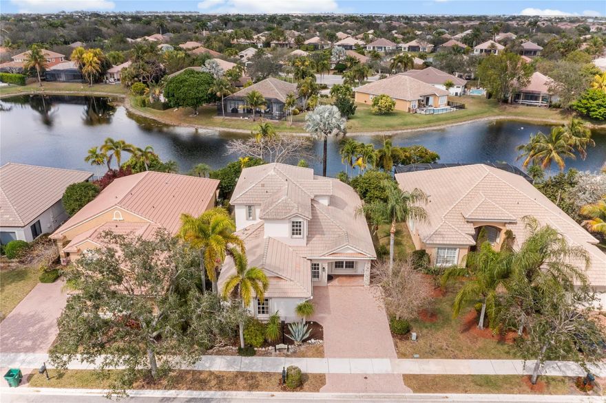 Lowest Priced Pool Home In All Of West Parkland! Stunning Islamorada Model w/4 Beds, 3 Baths + Loft Area, Pool Home Situated On A Waterfront Lot Steps Away From The Clubhouse. Open Kitchen w/Granite Counters, Island, Pantry & Breakfast Area. Master Suite Features Walk-In Closets, Dual Sinks & Vanities, & Separate Tub & Shower. Home Secured w/Accordion Shutters, Built-Ins Throughout & Freshly Painted Interior. Spacious Outside Area w/Screened-In Patio, Extended Pavers, Pool & Spa Overlooking Breathtaking Water Views Perfect For Entertaining. 24-Hour Guard Gated Community. Resort Style Amenities, Clubhouse, Pool & Spa, Fitness Center, Billiard Room, Tennis, Basketball & So Much More. Bordered By 3 Of Parkland's A Rated Schools, Close To Major Shopping, Restaurants, Highways & Much More.