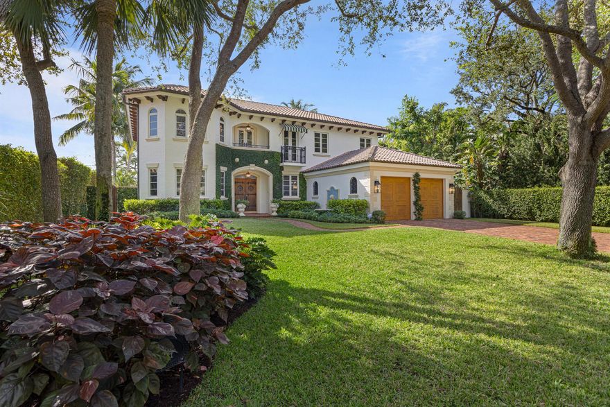 In a privately treed garden setting, this transitional jewel fluently captures Addison Mizner's classic style. Pecky cypress corbels and beams, barrel tile roof, copper gutters, Spanish-tiled fountain, antiqued brick walkways, and columned loggia. A monumental outdoor fireplace anchors the brick-inlaid Portuguese limestone patio around the beautiful fountained pool with swim shelves all controlled by a Jandy automated pool operating system. A summer kitchen and built-in professional DACOR gas grill allow alfresco dining under the coconut palms and chandelier lit loggia/patio.