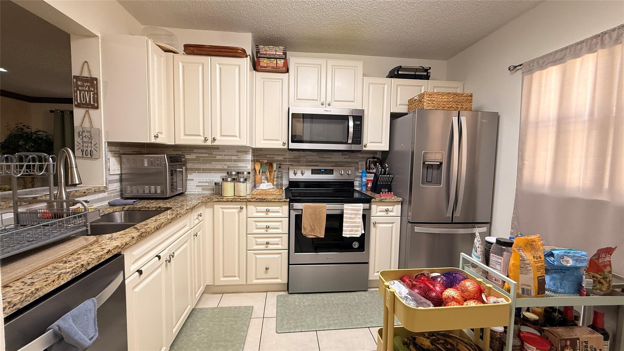 Welcome to this beautifully maintained 2/2 condo located in a highly desirable community in Coral Springs. Situated on the second floor, this spacious unit features a thoughtfully designed layout. Enjoy laminate wood flooring in the bedrooms and tile flooring throughout the main living areas. The updated kitchen boasts granite countertops, stainless steel appliances, and ample cabinet space. The bathrooms have been partially remodeled. Walk-in closet in the master bedroom! Windows are impact! And hurricane shutters on the screened balcony! The convenience of an in-unit washer and dryer! Located just minutes from good-rated schools, shopping centers, restaurants, and major highways, this condo combines comfort with unbeatable convenience. Don’t miss out! Schedule your showing today!