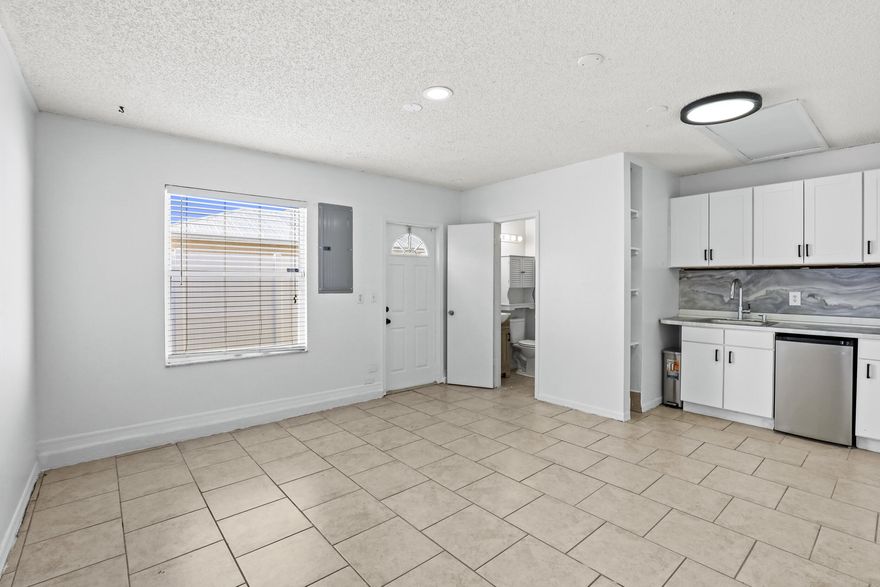 Cozy and private efficiency for rent in Port Saint Lucie! This move-in ready unit features tile flooring throughout, a bright open living space, kitchenette with white cabinetry, sink, mini refrigerator, and modern backsplash, plus a private bathroom. The unit offers a separate private entrance, recessed lighting, and a clean, functional layout ideal for comfortable everyday living. Conveniently located near shopping, dining, schools, parks, and major roadways. Perfect for one occupant looking for privacy, convenience, and an affordable rental option in Port Saint Lucie. Schedule your showing today!