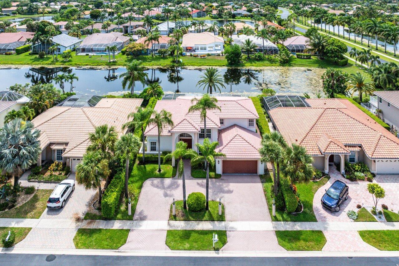 ''Spacious 4-bedroom, 3-bath lakefront pool home in a boutique gated community! This extended Flamingo model offers 4 extra feet of living space, soaring vaulted ceilings, added windows for abundant natural light, a wet bar, updated appliances, electric hurricane shutters, and a circular driveway. The 4th bedroom is currently a loft, easily convertible to a full bedroom. Serene lake views from your private pool. Price reflects the need for updates and the age of the roof--perfect opportunity to customize to your style!''
