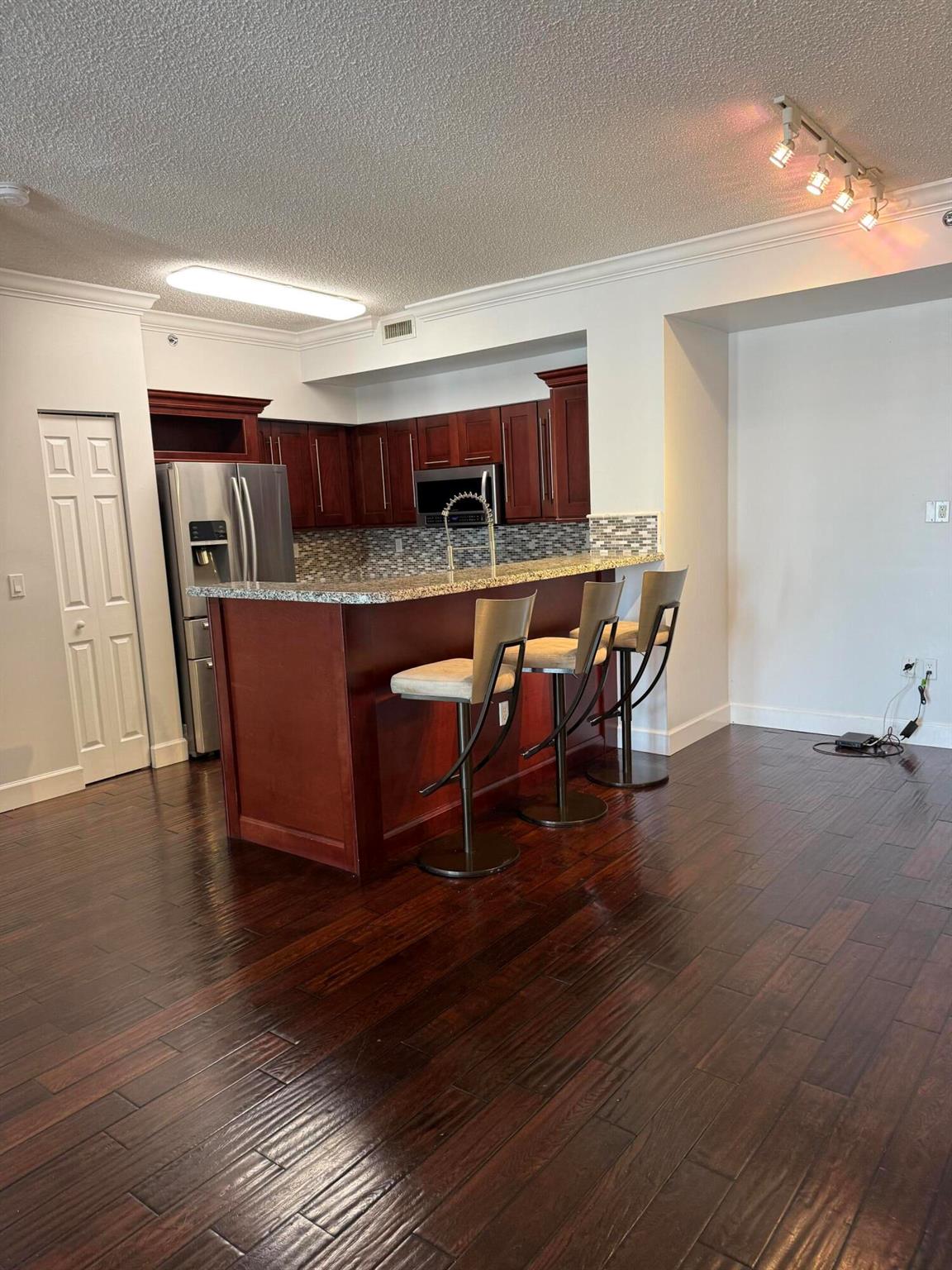 FRESHLY painted, BRAND NEW carpeting in both bedrooms, wood floor in living area and kitchen. Newer upgraded stainless appliances, wood cabinets, granite counters in kitchen and both baths, NEW washer and dryer, NEW easy open, sliding glass door to a covered balcony with a view of Clear Lake. Large rooms, spacious closets, great split floor plan layout with both bedrooms having their own full bathrooms; and the perfect area location. Close to everything West Palm Beach and Palm Beach has to offer. Down Town, PBA University, Shopping, dining, festivals, beaches, airport, Tri-Rail and Brightline train stations, and I95 all just minutes/seconds away. Live, Learn, Work, Play.