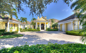 Imagine yourself living in one of the most elegant homes in one of the most prestigious neighborhoods in the Palm Beaches. That's what you'll be doing as you drive through the gates of Old Marsh Golf Club and up the treed circular driveway of this stately 5 bedroom, 61/2 bath custom estate home. Situated on a beautifully landscaped, nearly 2/3 of an acre lot, this 6,027 square foot home is filled with extraordinary amenities. Impeccable decorating envelops you throughout with marble and hardwood flooring, custom draperies and motorized blinds, rich built-in wood cabinetry and crown moldings, painted and wood carved tray ceilings, marble backsplashes, granite countertops, sophisticated lighting fixtures, wainscoting, and a myriad of top-of-the-line conveniences.