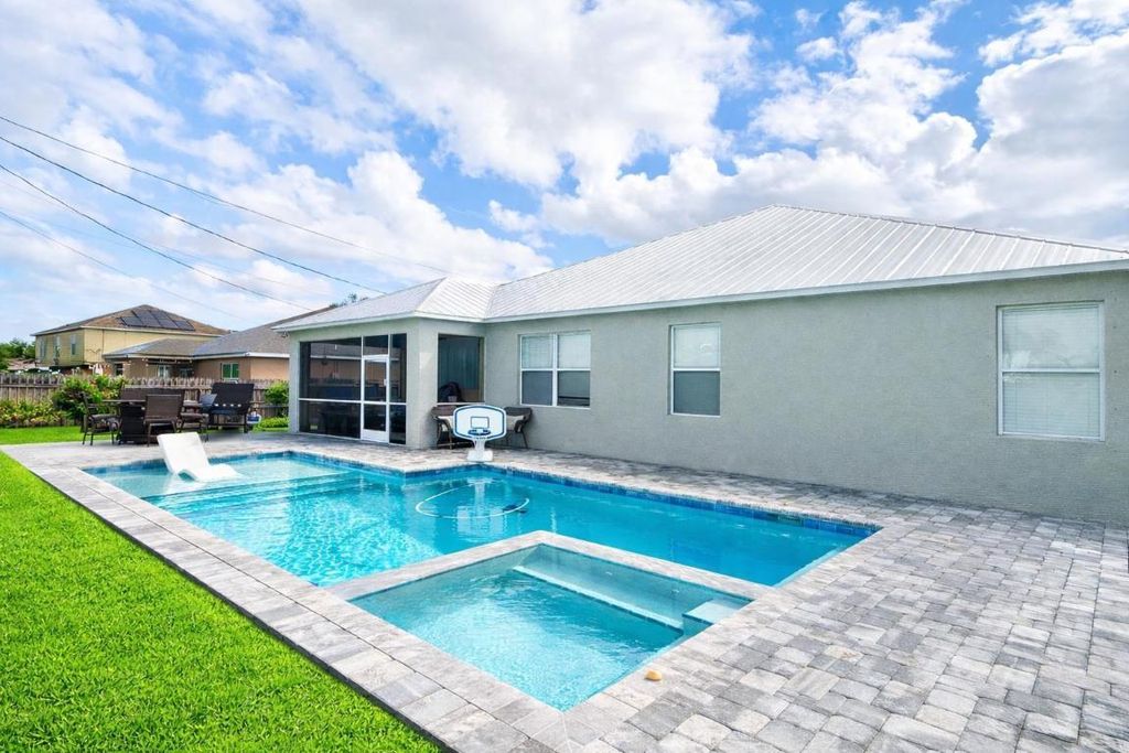 Photo of 941 SW Mcelroy Avenue, Port Saint Lucie, FL 34953 (MLS # R11152094)