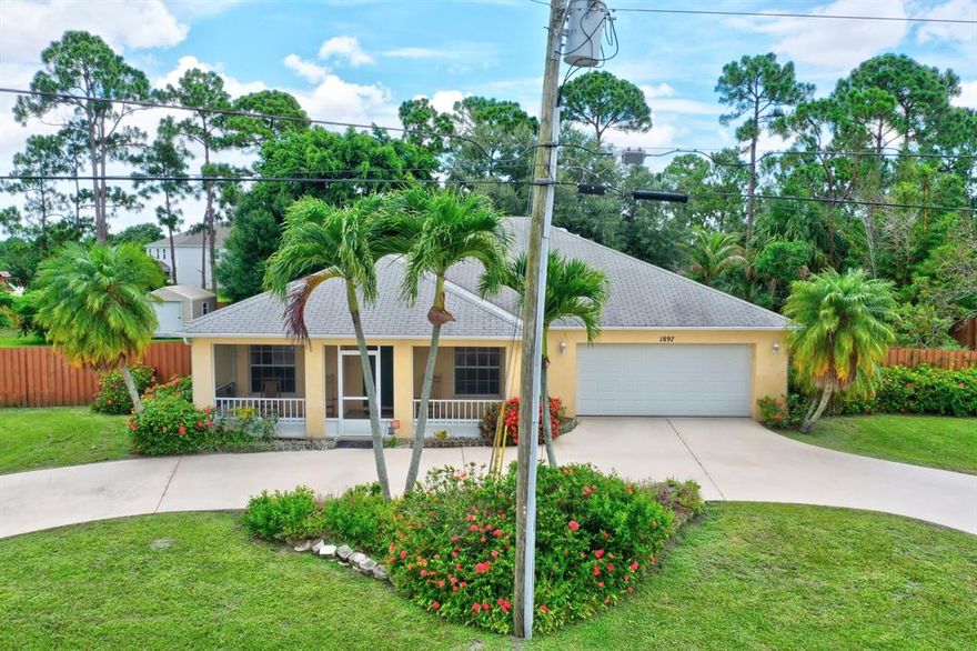 LOCATION, LOCATION, LOCATION... This 3/2/2 double (1/2 acre) lot home is on a canal, fully fenced with circular driveway and huge wall to wall back and front screened porches.  Fully tiled, oversized master with dual sink and shower and other bedrooms are 2 inches larger than normal size. Large eat-in kitchen with Stainless steel french door refrigerator and dishwasher.  Formal living and dining room with long breakfast bar.  2017 A/C unit, 2018 water heater and new garage door opener. Shed in backyard, fruit trees include mango, lychee and black olive.. Maple and Oak trees provide lots of shade. Centrally located near Gatlin, Cleveland Clinic, Walmart, Sam's Club and Tradition.  Good school district and great access to the highways.