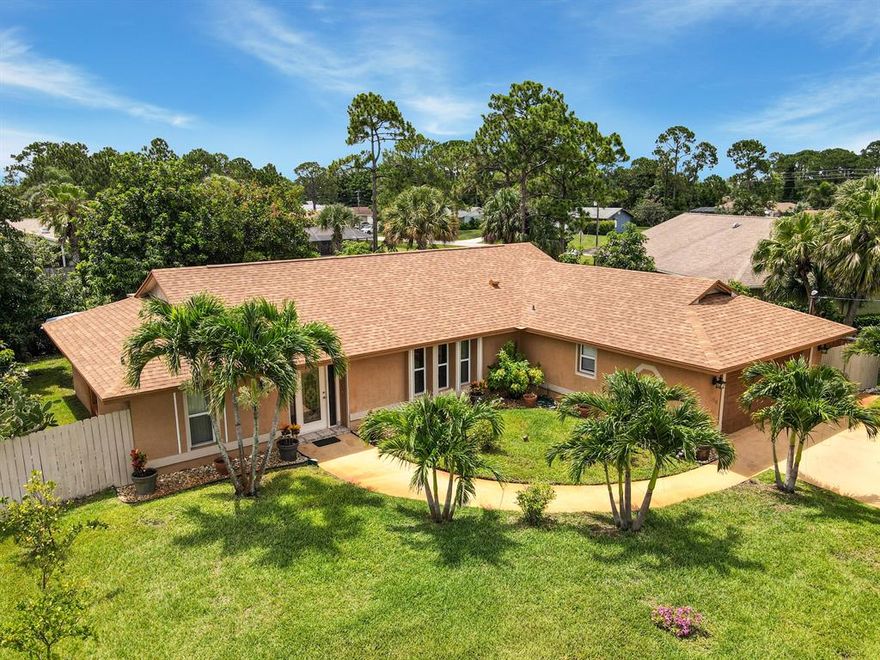 Open House June 18th & 19th from 1 to 3PM! (No Showings Before the Open House)
The palm lined drive gives way to this marvelous single family home centrally located in the highly desirable River Park area, just minutes to Crosstown Parkway, and Downtown Port St Lucie. The thoughtfully landscaped grounds invite you to the front door. Upon entrance, you are greeted by ceramic tile floors. A bright and open floor plan seamlessly connects the kitchen to the living room and leads to the inviting, sunny back patio. Meticulous attention to detail is presented in the kitchen with pristine granite countertops, custom cabinets, and stainless steel appliances. Adjacent to the living room, there is a comfortable family room and dining room gleaming with natural light. An oversized master suite with two walk-in closets, leads to the elegant master bathroom. On the other side of this 1900 square foot home you will find two more large bedrooms with their own walk in closets along with a nice guest bathroom that has access to the back patio. The backyard is full of fruit trees, and a large patio provides plentiful space for gardening and entertaining. The two car garage boasts the solid construction of this concrete block home complete with a new roof 2019, new air conditioning 2021, and an upgraded Miami-Dade garage door. Walking Distance from Floresta Elementary and Kiwanis Park
