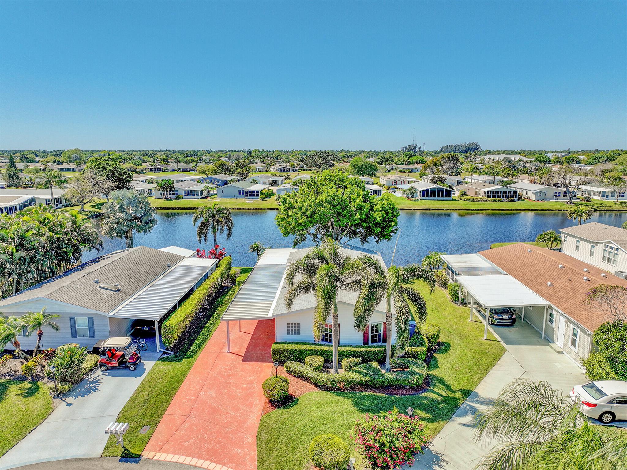 $4000 credit to Buyer at closing. Discover the perfect blend of comfort & leisure in this waterfront property, designed specifically for those aged 55 & better. The heart of this 2 bedroom + den open concept residence features a beautiful kitchen, newer cabinets, granite counters & a spacious island with storage. The sunroom, overlooking the water, is a joy anytime of the day. Nestled within a vibrant community, residents enjoy a wealth of amenities, including golf, tennis, pickle ball, swimming and various clubs that cater to diverse interests. There's truly something for everyone in Savanna Club with its 3 clubhouses, pools, fitness centers and so many activities. Shed, ex-wide driveway, hurricane panels, roof 2018, HVAC 2024. Land Lease.