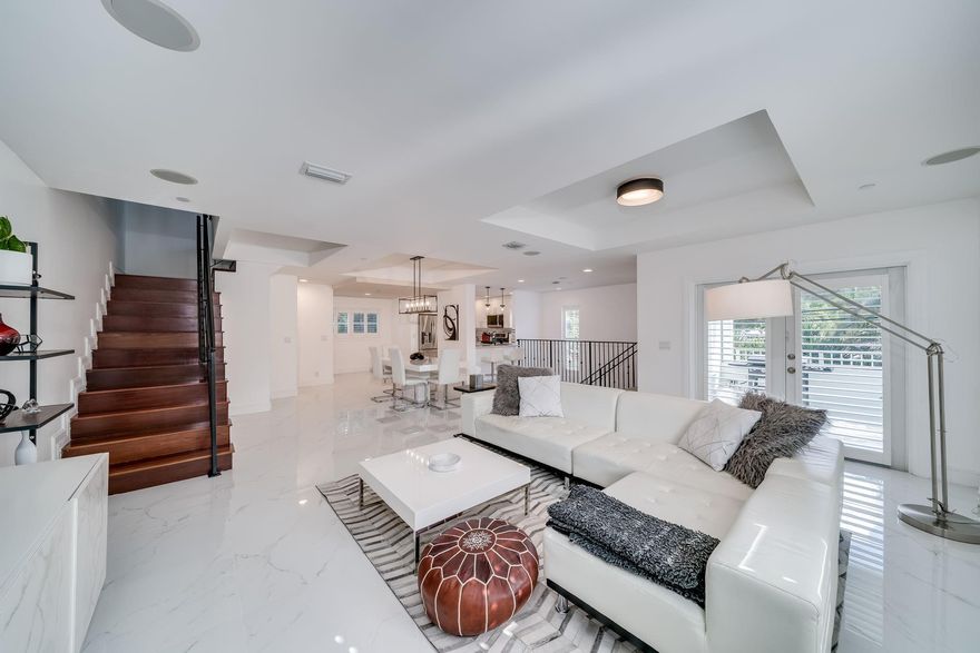 NO HOA FEES + Ultra-Modern Updates. Largest home in an exclusive 3-unit community with 2,800+ sq ft under air. This 3 bed, 3.5 bath end-unit includes a private garage and offers rare privacy with walkable access to shops, restaurants, salons, grocery stores and more. Features oversized marble-look ceramic tile throughout, Brazilian hardwood stairs, tray ceilings, abundant natural light and built-in surround-sound. Updated kitchen with stainless steel appliances and modern cabinetry. Two private balconies, impact windows, whole-house water softener and new third-floor HVAC complete this high-end home.