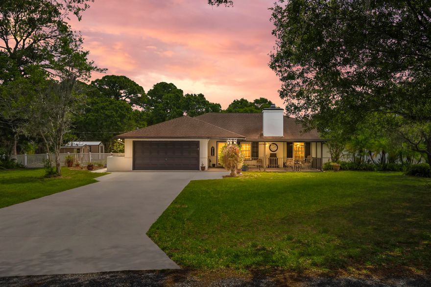 Welcome to quiet country living on one acre in the heart of White City in unincorporated St. Lucie County. This custom-built pool-home offers 3 bedrooms, 2 bathrooms, plus two flexible office spaces. Inside features include multiple living areas, a brick wood-burning fireplace, a large laundry/craft room, and kitchen views of the sparkling pool. Recent updates include a refreshed guest bath, neutral paint, and luxury vinyl plank flooring in the main areas.  Outside, enjoy a fenced, park-like acre with NO HOA, mature trees, and ample space for boats, RVs, or outbuildings. The paved driveway fits multiple vehicles, and a double gate allows easy backyard access. Located on a dead-end street near US1