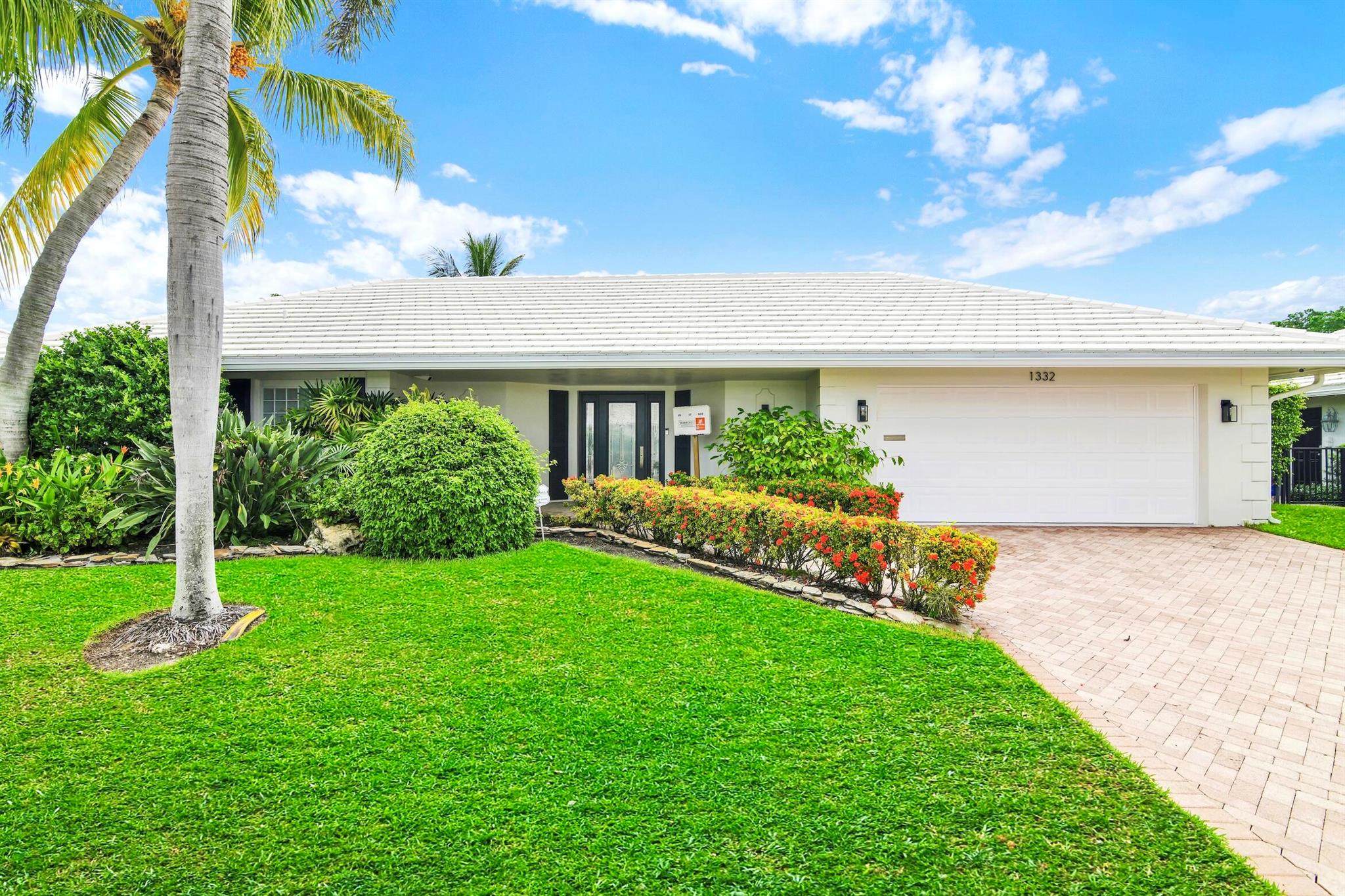 A rare, newly renovated Camino Gardens waterfront residence with 85+/- ft of frontage and ocean access. Features include a new kitchen and baths, sleek marble floors, vaulted-ceiling living room, contemporary chef's kitchen with island and casual dining, plus a versatile office/guest suite/gym. The primary suite offers pool access, a spa bath with freestanding tub, curbless shower, and custom closet. Two guest bedrooms have walk-ins. Outdoor living shines with a screened lanai, saltwater pool, and dock with lift and dual ramps. Additional perks: Wi-Fi irrigation, 2-bay garage with EV charger, and newer roof. Ideally close to Mizner Park, dining, beaches, and A-rated schools.
